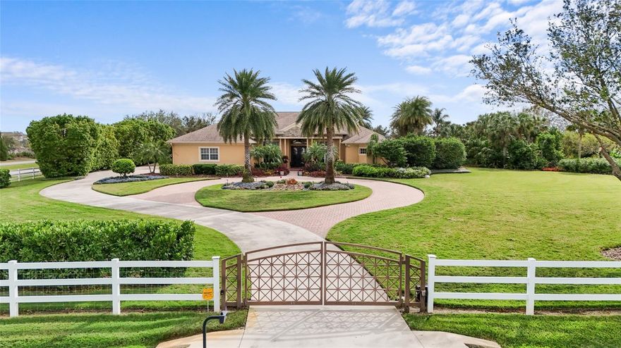 Looking for a sanctuary? Your own little bubble of private paradise close into the city? Discover refined living in this custom Pruett-built, low-maintenance home designed with exceptional attention to detail. Sitting on 5 acres of serene, manicured land, this home features trey ceilings, a granite gourmet kitchen with a hidden pantry, wet bar, and two expansive islands perfect for entertaining. The open layout flows seamlessly into a huge lanai with a heated pool, spa, and fountain, all managed by an automated Jandy system. A standout feature is the whole house Generac generator and extensive 60-panel solar system, providing efficient energy to the property, along with propane gas appliances and a cozy fireplace. For your hobbies and storage needs, there’s a massive 40 x 60 RV garage with a 58’ depth, its own water system, and a detached workshop/garage equipped with water and electricity, overlooking a tranquil, stocked lake. The home's spacious rooms, high tray ceilings, and neutral color palette offer a seamless move-in experience. The expansive Master Suite impresses with double walk-in closets, an elegant bath, and easy-care finishes. Outside, the screened area boasts a covered lanai and veranda, both set on heavy paver decking, designed for minimal upkeep so you can enjoy the lifestyle amenities nearby. Located walking distance from 2 promenade schools (Sarasota Military Academy and TCA Sarasota) just minutes from the Interstate, you’ll have easy access to shopping at The Mall at University Town Center, high end dining, and recreation, making this property a perfect blend of luxury and convenience. Priced for today’s market, this unique home is a must-see!