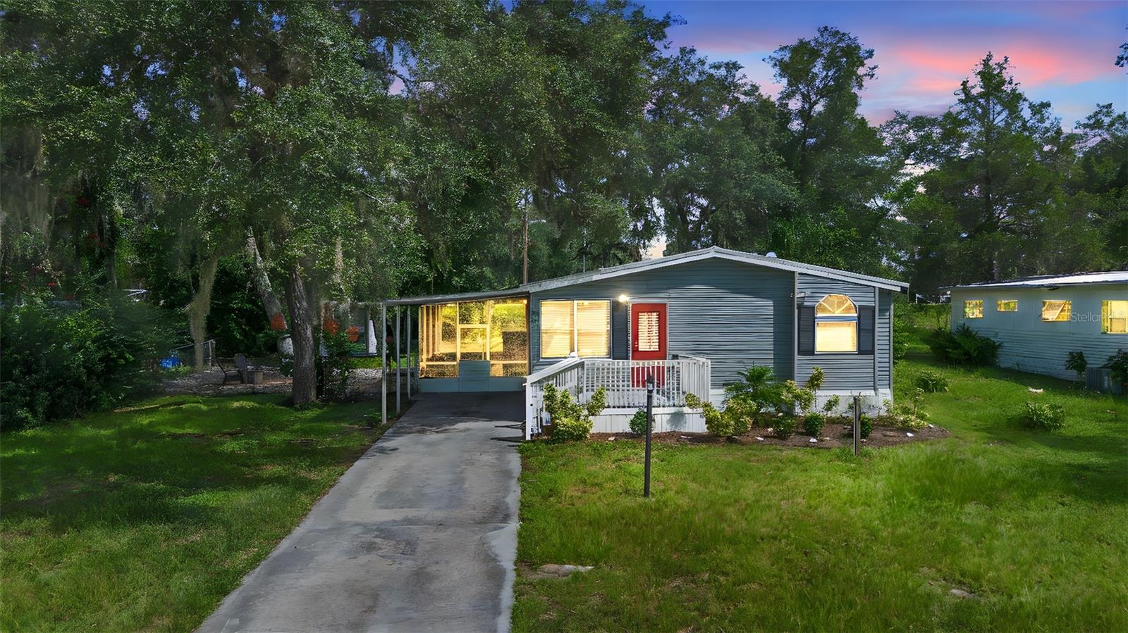 North DeLand - Step into your beautifully upgraded haven, a 3-bedroom, 2-bath double-wide home designed for comfortable living and effortless entertaining. The heart of this home is a chef's dream kitchen, featuring classic kitchen cabinets, stunning granite countertops, and sleek stainless steel appliances. Imagine preparing meals in a space that's both functional and stylish, then enjoying them in a bright and airy living area bathed in natural light. The home boasts elegant laminate floors throughout, adding warmth and sophistication. Extend your living space to the outdoors with a screened side porch, perfect for relaxing with a morning coffee or enjoying a peaceful evening. A convenient one-car carport and a cozy wood fireplace complete this exceptional home. Metal roof 2018 - no leaks ever. Electrical and hot water 2018, AC and ALL plumbing 2024. This home offers a perfect blend of modern updates and classic charm, ready for you to move in and create lasting memories. Schedule your showing today!