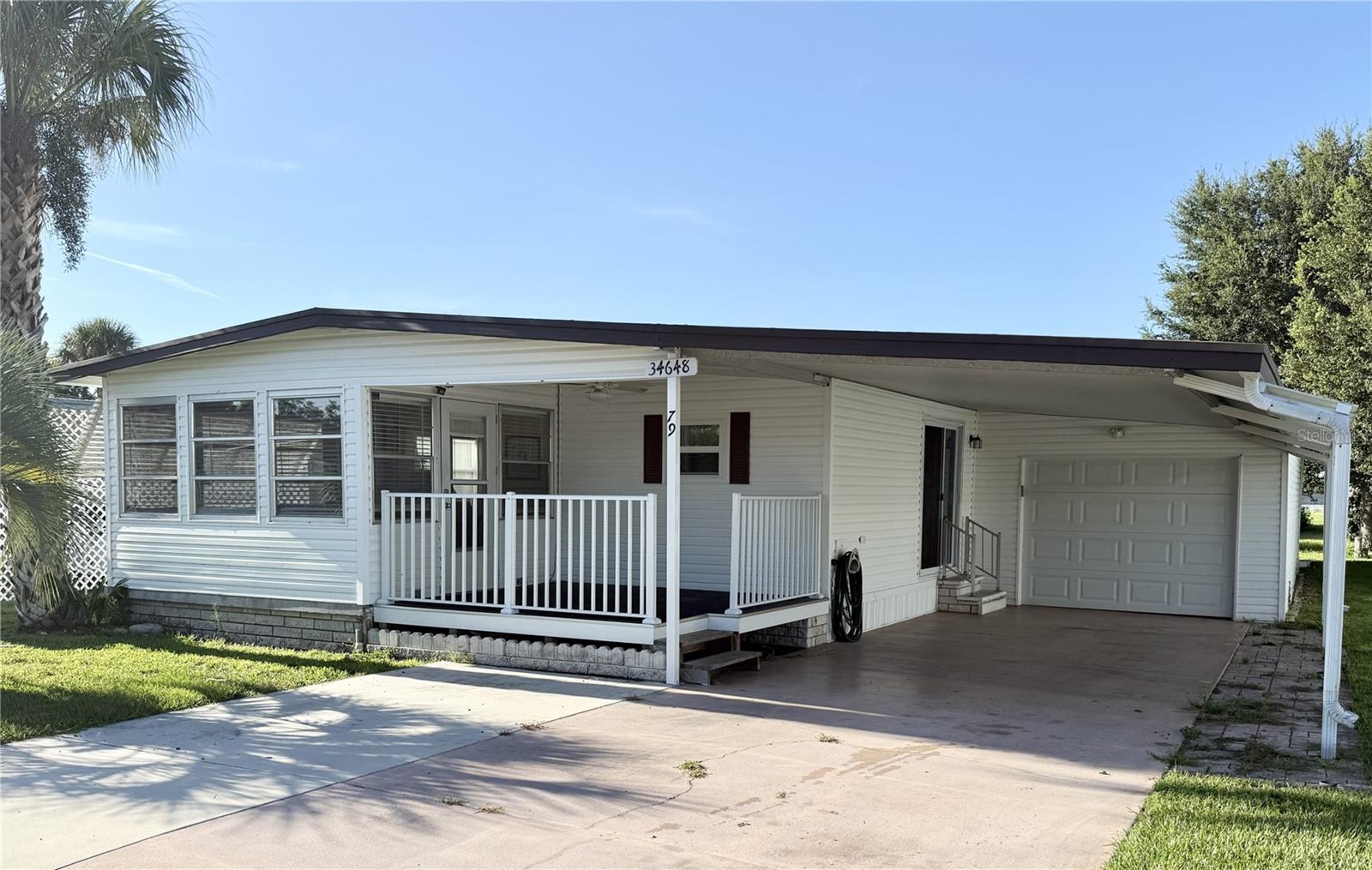 Welcome to Tippecanoe Village, a vibrant 55+ community where you own the land and enjoy a low HOA of just $80/month. Your dues cover water, sewer, trash, access to the community pool, shuffleboard courts, clubhouse, and even RV/boat parking. This fully furnished home is truly move-in ready—just bring your toothbrush! Inside, you’ll love the light and bright open floor plan. The spacious kitchen offers ample cabinet and counter space, along with a peninsula island perfect for chatting with friends or family while cooking. The dining area is ideal for entertaining or enjoying game nights. The hallway leading to the primary suite is extra wide for added comfort. Both bedrooms are filled with natural light, and the secondary bedroom boasts a generous walk-in closet. You’ll also appreciate the indoor laundry room with bonus storage space. This home has been well cared for and thoughtfully updated with a roof recoated in 2025, new flooring and carpet on the east side in 2024, new plywood and flooring on the west side in 2020, new insulation and vapor barrier installed in 2023, and all new windows in 2021. The spacious garage (13’ x 28’) features a laundry sink and workbench, while the large shed (10’ x 16’) provides plenty of extra storage. A 4-Point Inspection was completed on April 25, 2025, and the report will be provided by the seller for peace of mind. Come enjoy all that Tippecanoe Village has to offer—meet new friends at the clubhouse, relax by the pool, and embrace the Florida lifestyle you’ve been dreaming of!