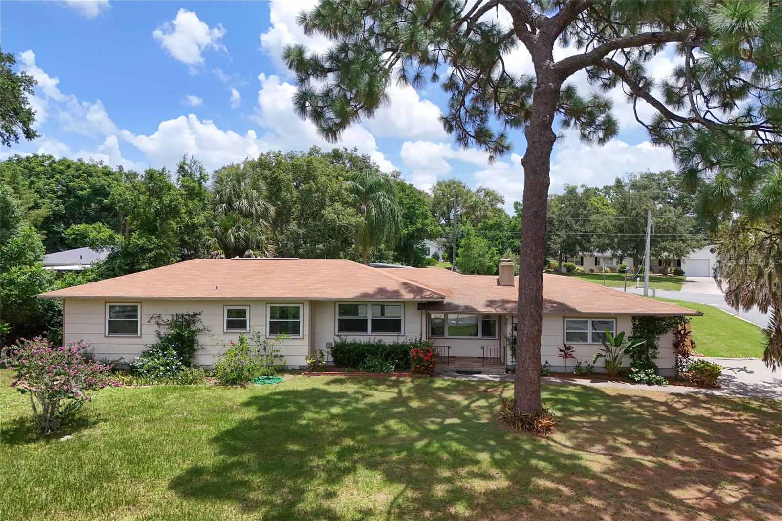 Check out this beautiful home located a mile away from downtown Mount Dora! Situated in the wonderful community of Pine Crest, this pool home welcomes the Florida life! Enjoy the luxury of being a short walk or golf cart ride to downtown Mount Dora, park and treat yourself to some coffee and shopping or pickleball! Then retreat from the heat to your screened-in swimming pool with rock waterfall. While the sun is setting, one can enjoy yard games on this .48 acre, corner lot, or walk the Lake Gertrude trail, which is only a block away. It is rare to find a historic home with character, a spacious lot, and only a mile away from downtown Mount Dora. Don't wait to make this home yours!