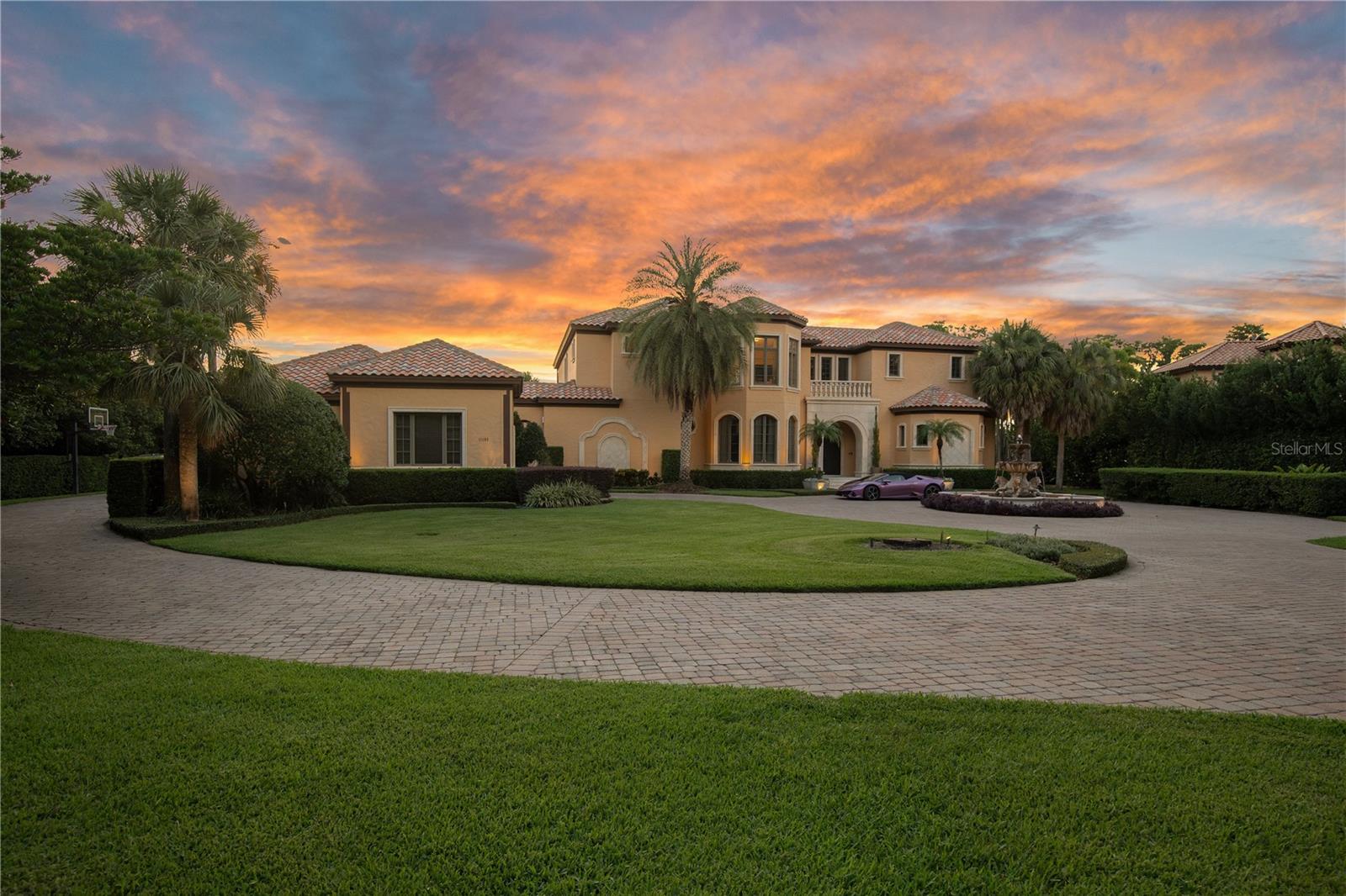 Step into timeless elegance, luxury, and sophisticated living. Located in the exclusive man-gated community of Lake Butler Sound—one of Central Florida’s most prestigious communities. From the moment you enter, you're greeted by high-end finishes, open-concept living space, and meticulous attention to detail. This stunning residence offers nearly 9,000 sqft of elevated living space featuring 5 spacious bedrooms, 8 luxurious bathrooms, and your very own private detached guest suite offering unparalleled comfort, perfect for having guests and upscale hosting. Enjoy cinematic experiences in your private movie theatre, with reclined seating, host unforgettable gatherings in the state-of-the-art entertainment center, and set the perfect ambiance with built-in speakers flowing music throughout the residence. This home is beautifully designed with an indoor-outdoor flow, making it an entertainer's dream. Step outside to a serene koi pond, lush landscaping, heated pool and your very own dock with direct water access to the Butler Chain of Lakes. This rare estate offers a combination of space, style, and status—a truly unmatched opportunity in Windermere.