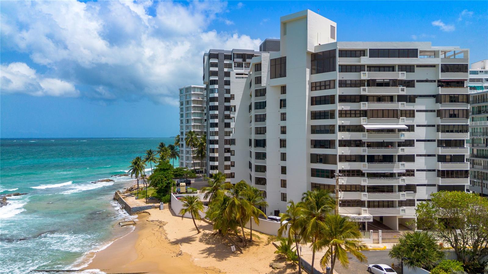 Welcome to Olympic Tower, a boutique oceanfront condominium in Condado where privacy meets convenience. With only one residence per floor, the elevator opens directly into your private entryway, with the added benefit of a separate service elevator and storage area.
This residence offers 3,020 square feet of interior space with 3 bedrooms, 2.5 bathrooms, an office, and a flexible layout that can easily convert to 4 bedrooms. Expansive living and dining areas highlight panoramic ocean views, complemented by a large kitchen and family room that provide both comfort and functionality. Storm shutters are already installed for added protection.
The primary suite includes a walk-in closet and ensuite bathroom with double vanities. Two additional bedrooms share a full bath, each with ample closet space. Two parking spaces are included.
Olympic Tower combines essential conveniences with a privileged location: 24-hour security, full power generator, and water cistern. The building sits on a quiet one-way street, with direct access to a tranquil beachfront where a natural ocean pool creates an ideal spot for swimming. Despite its serene setting, the property is just steps from St. John’s and Robinson Schools, Ashford Medical Center, supermarkets, and Condado’s renowned dining and shopping.