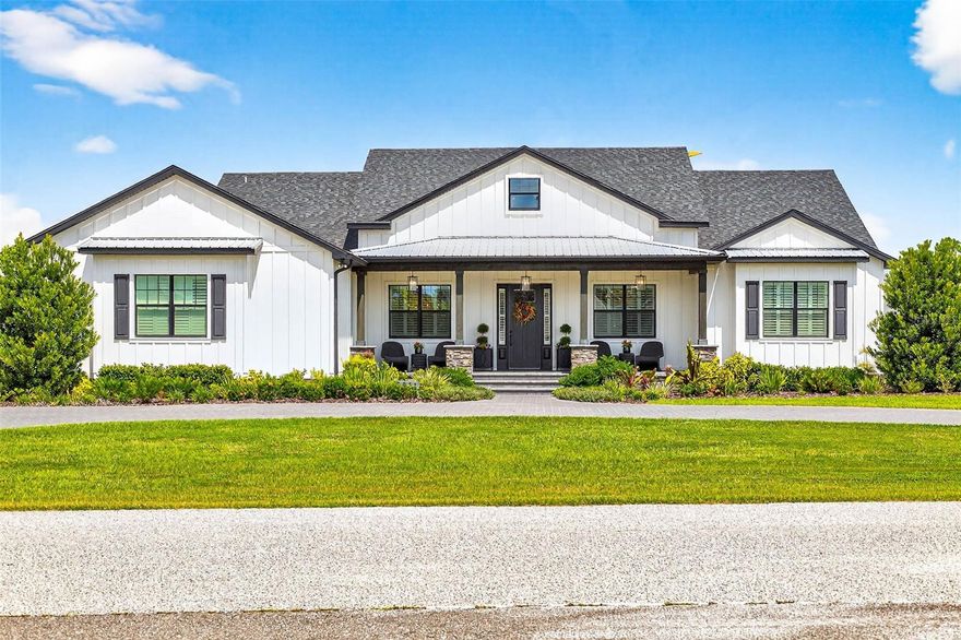 Welcome to your dream home! Featured in Florida Design Magazine, this stunning 4-bedroom, 3.5-bath modern farmhouse blends classic charm with modern luxury finishes throughout, including high end Arteriors and Hinkley lighting features, Emtek Cabinetry hardware and Brizo  plumbing features. Step inside to 10 foot ceilings, wide-plank hardwood floors, and an open-concept layout that’s perfect for entertaining. The gourmet kitchen features quartz countertops, stainless steel appliances and a beautiful waterfall island.The plantation shutters and large windows flood the family room/entertainment area with natural light. Custom draperies and high end wallpaper have elevated this home to the next level. French doors open to the professionally landscaped back yard and pool area where you can enjoy serene evenings cooking in the outdoor kitchen on the covered back porch. Retreat to the primary suite with a spa-inspired bathroom, double vanities, soaking tub, and oversized walk-in closet. Three additional bedrooms offer plenty of space and comfort. This property provides flexibility for a home office with the den/office located off the family room. It is conveniently located near top schools, shopping, and dining—you won’t want to miss it! Schedule your private tour today.