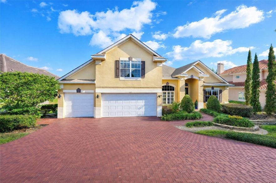 One or more photo(s) has been virtually staged. Spectacular water and golf views on the signature hole of Sweetwater Country Club! Tranquil outdoor living with a screened pool overlooking the 11th fairway. This 5-bedroom, 4-bath home features a 3-car garage, bonus room, and over $40,000 in recent improvements.

Immaculate grounds and contemporary elevation welcome you home. A long stone paver driveway is framed by lush landscaping, ornamental trees, and accent lighting. Step inside to enjoy panoramic water and golf views throughout the main living areas. Open and spacious with arched openings, volume/vaulted/tray ceilings, crown molding, plantation shutters, and select laminate flooring. Fresh decorator paint inside and out.

The open-concept kitchen, living, and dining areas are ideal for entertaining. The kitchen offers quality wood cabinetry, stainless steel appliances, granite countertops, a center island, and snack bar. The primary suite is downstairs with a spa-like bath featuring dual vanities, garden tub, and separate shower. Three-way split floor plan provides privacy.

A 5th bedroom and full bath upstairs allow for a potential second primary suite. Bonus room with laminate flooring offers flexible space for an office or den. Enjoy spring-fed Lake Brantley for swimming, skiing, and fishing, plus nearby parks, tennis courts, Sweetwater Beach, and playground.