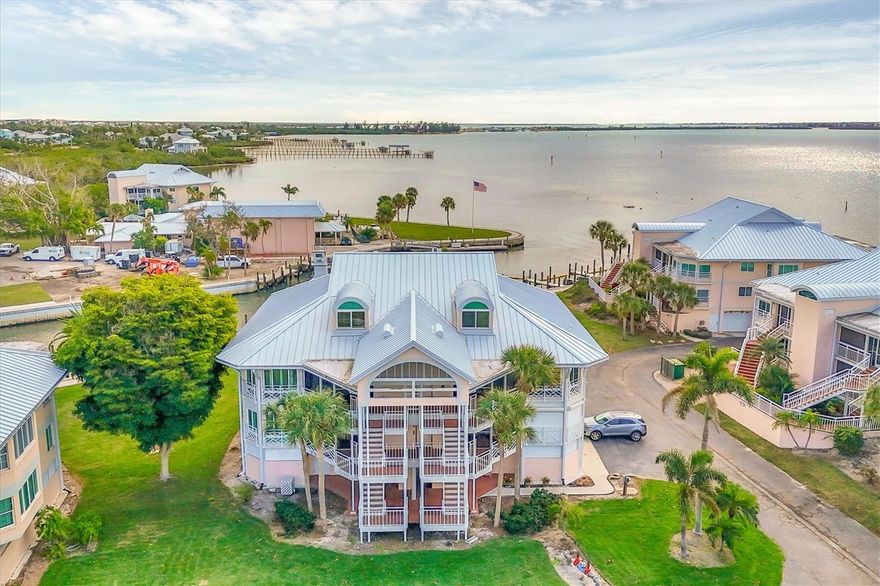 Experience elevated coastal living at Placida Harbour Club, an exceptional amenity-rich waterfront community that blends refined luxury with a true resort-style lifestyle. This sought-after enclave offers its own deep-water marina and private ferry service to the pristine, uncrowded beaches of Little Gasparilla Island. Extensive community-wide improvements and renovations are nearing completion, further enhancing Placida Harbour Club’s reputation as one of the premier waterfront destinations on the mainland. Boating enthusiasts will love the newly renovated marina featuring dredging, new seawalls, scenic waterfront walkways, and composite docks with 70 slips equipped with electric and water, plus a kayak launch and direct access to the Intracoastal Waterway and Gulf of Mexico. A new private ferry accommodating up to 20 passengers provides effortless access to the island’s clubhouse, pool, and beaches, with a brand-new composite pier and additional boat slips on Little Gasparilla Island scheduled for completion in February 2026. Residents also enjoy two clubhouses and pools on the mainland—one overlooking the Intracoastal with a heated pool perfect for water aerobics or simply relaxing while boats pass by, and another overlooking the marina where dolphins and manatees are frequent visitors—along with onsite pickleball and tennis courts & a newly expanded and renovated fitness center.  This prestigious residence offers the ultimate in turnkey convenience, being fully furnished and ready for immediate enjoyment, and presents a rare opportunity to own one of the very few homes in Placida Harbour Club featuring a four-car tandem garage with extra storage. As the largest floor plan in the community, this spacious upper-level residence boasts soaring ceilings, spectacular marina and Intracoastal views, and a well-designed layout with three bedrooms, three-and-a-half baths, a loft, and abundant storage. The lower level includes the primary suite, an additional en suite, the main living area, a well-appointed kitchen with breakfast nook/sunroom, laundry, and a half bath, while the upper level offers a private en suite, a versatile loft with alcove, and walk-in attic storage. Thoughtful updates include a Culligan water softener (2024), two new air-conditioning units (2024), a tankless water heater (2024), updated KitchenAid built-in convection oven/microwave & dishwasher (2024) and a freshly painted exterior with metal roof and gutters (2023-2024). The gourmet kitchen features a Sub-Zero refrigerator/freezer, Jenn Air cooktop, warming drawer, built-in wine cooler, custom cabinetry, and an elegant custom hand painted tray ceiling with crown molding. Polished shell stone flooring with limestone and fossil accents highlights the main living areas, complemented by engineered wood flooring in the lower level suites, plantation shutters, hurricane shutters, and a spa-inspired primary bath featuring a rain shower, with jets, customizable temperature settings and accent lighting . From your private lanai, savor sweeping marina and Intracoastal views while watching boats glide by and dolphins and manatees play, all just 1.5 miles from the Boca Grande Causeway and close to golf courses, beaches, dining, and more. County Record shows 4 bedrooms, A/C sq. feet as 2869 and total sq. feet as 2869. Builder shows 2940 sq. feet A/C and total sq. feet at 3423. Buyer’s and buyer’s agent must complete due diligence.