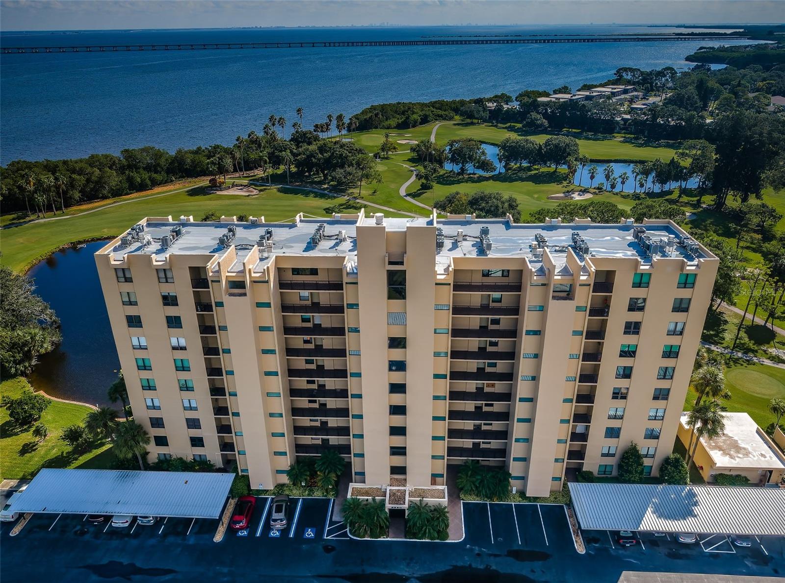 Breathtaking Views, Unmatched lifestyle – Welcome to Cove Cay, a gated, golf course community located along Tampa Bay! If you've been dreaming of a home with a view, your moment has arrived. This stunning 5th-floor residence in the luxurious Cove Cay Condo Community offers panoramic vistas that will leave you speechless — from the shimmering waters of Tampa Bay to the lush greens of the Cove Cay Golf Course, and the tranquil pond just below. By night, the illuminated Bayside Bridge transforms the skyline into a dazzling spectacle, all visible from your expansive Great Room or your screened-in lanai. Modern elegance meets coastal charm! This beautifully updated 1-bedroom, 1.5-bath condo is the epitome of refined Florida living. Step into a light-filled space featuring easy-care vinyl flooring, a spacious primary suite with a walk-in closet, and a remodeled ensuite bath complete with a double-sink vanity and shaker cabinetry. The powder room off the entry is perfect for guests, and your private laundry room with extra storage is conveniently located just across the hall. The Coastal Kitchen is a chef’s dream — outfitted with shaker-style white cabinets, quartz countertops, a tiled backsplash, and thoughtful touches like a built-in spice rack and curio shelf. There’s even room for a cozy eat-in breakfast nook to start your mornings with a view. Value added improvements include a new roof and elevators in the building, assigned carport parking, 24-hour guard-gated community, heated inground pool and spa, privately owned Golf club where you can play Golf, host an event or enjoy a meal at Bay View Grill, Cove Cay’s delightful restaurant and for the boaters, there is Cove Cay Marina where you can rent a boat, store your boat, rent a kayak or have a beverage at AJ’s Dockside Grill! Whether you're seeking a full-time residence or a vacation retreat, this condo offers the perfect blend of serenity, luxury, and convenience. With assessments already paid and upgrades in place, all that’s left is for you to move in and start living your best Florida life.