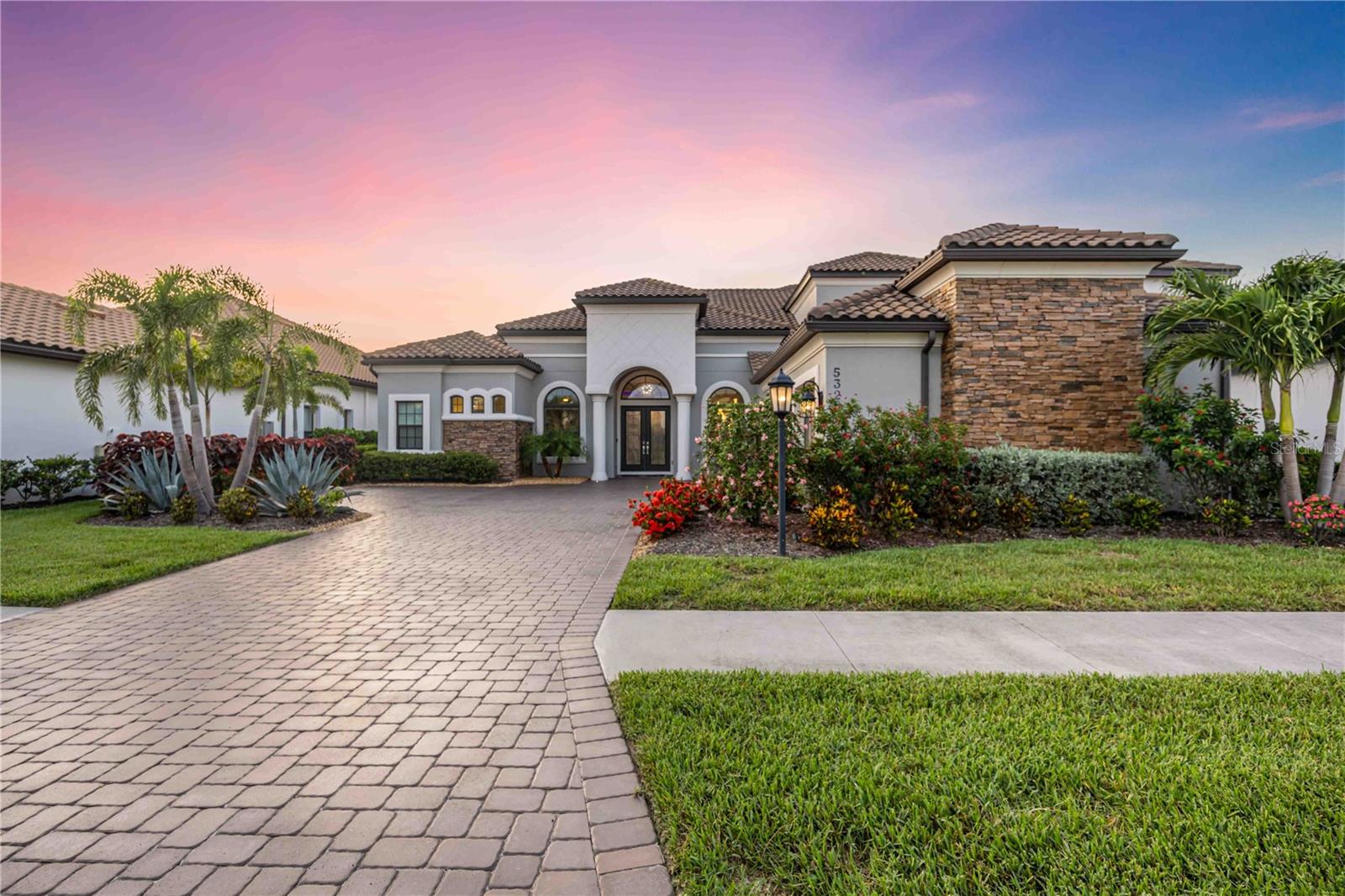 Live where luxury meets lifestyle! Welcome to your dream home—a stunning and meticulously upgraded 4-bedroom, 6 bath luxury estate that offers the perfect blend of elegance, comfort, and state-of-the-art amenities. Every detail of this residence has been thoughtfully designed for a lifestyle of sophistication and ease. The home has a whole-house water filtration system (2025) with alkaline water faucet in the kitchen that features upgraded countertops and extra cabinetry that were added to the kitchen bar. Feel the luxury with 7” custom crown molding and baseboards throughout the home. Tray ceilings with UV light and remote, and Recessed lighting throughout the home provide ambient illumination. The upgrades don't end there: enjoy a spacious bonus room, a Gas fireplace for cozy evenings, resort style window treatments with a remote control. The Gourmet Kitchen features Designer countertops and bar area with custom extra cabinets, Modern appliances and plenty of prep space. It allows a seamless access to the indoor and outdoor living areas from the kitchen perfect for entertaining guests. Enjoy luxurious outdoor living at its finest on your expansive lanai with a mini built-in kitchen, Paver lighting front and back, in the pool area, and on the pool cage. The ceiling fans with lights feature WiFi boosters in the lanai. Enjoy your panoramic “noseeum” screen over the pool area for extra comfort and additional privacy with no backyard neighbors. The pool comes with separate heaters controlled via the ScreenLogic app. The 3 car garage offers finished floors. See the feature sheet for more details in upgrades. This move-in ready estate seamlessly blends high-end finishes with smart-home upgrades and energy efficiency. Whether you’re hosting guests, enjoying peaceful evenings by the pool, or simply living your day-to-day, this home caters to every need. The community features resort-style amenities for your ultimate living experience: Club house, restaurant, fitness center, pool, just to name a few. Take your chance to live this luxurious Florida lifestyle you have always dreamed of.