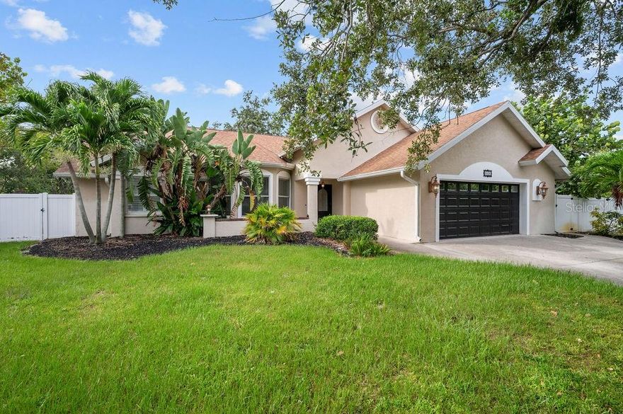 Welcome Home to Azalea Park! This 4 bedroom + den spacious home with 2.5 baths sits on one of the largest lots in the neighborhood! Situated on a quiet cul-de-sac, the large, fully fenced yard enjoys private water views. This spacious home features high ceilings and an open floor plan, with split bedrooms, open living space and a 2 car, air conditioned garage. You will love the chef's kitchen with skylights and high counter seating, granite counters and solid wood cabinetry. This home is full of extras - like your GE Monogram 6 burner gas stove with griddle and double oven, touchless Moen faucet (2022), separate ice maker mini-freezer (2020), wall mounted pot filler faucet, double oversized stainless sink, tankless hot water heater (2023), updated A/C (2024) and remote controlled kitchen hood (2024). Enjoy the serene views through French doors to the large patio space. Attach your grill out back to the patio's propane hook up, and enjoy the privacy of your large yard with the mature landscaping while relaxing under the trellis.  You can even use the existing wiring hook up to add a spa. Or unwind inside the spacious family room with gas fireplace and built in entertainment center. The bedrooms have large windows with plantation shutters, ceiling fans and lighted closets. The den/office space with high coffered ceiling, is bright with natural light from the double glass doors and bay windows. The spacious primary bedroom, with private access to the side yard, has a large walk in closet with solid wood custom organizer. The primary bathroom includes dual glass bowl sinks and a walk-in shower with pebble shower floor, foot bath, dual shower heads and a soaking tub. All of this in the desirable Azalea Park neighborhood, with community pool and easy access to Robinson Preserve, DeSoto Memorial Park, the botanical gardens, and just minutes to the beaches of Anna Maria Island!