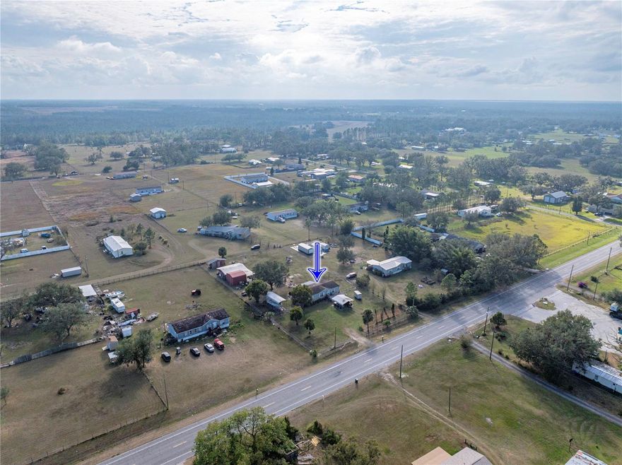 Enjoy peaceful country living in this 3/2 doublewide on 1.03 acres with open floor plan, high ceilings & enclosed patio. Fully fenced with 2 drive-through gates. Features gazebo w/electric, firepit & large covered area for vehicles/toys. Includes 24x30 workshop, 20x30 carport, add-on bldg w/electric & water, well pump house & 25 yd shooting range pergola. 50-amp RV/generator hookup. Updates: roof 2014, A/C 2018, well & septic 2022, dishwasher & dryer 2024. This property offers a rare combination of space, functionality, and outdoor amenities, perfect for those seeking privacy, hobbies, or room to grow.