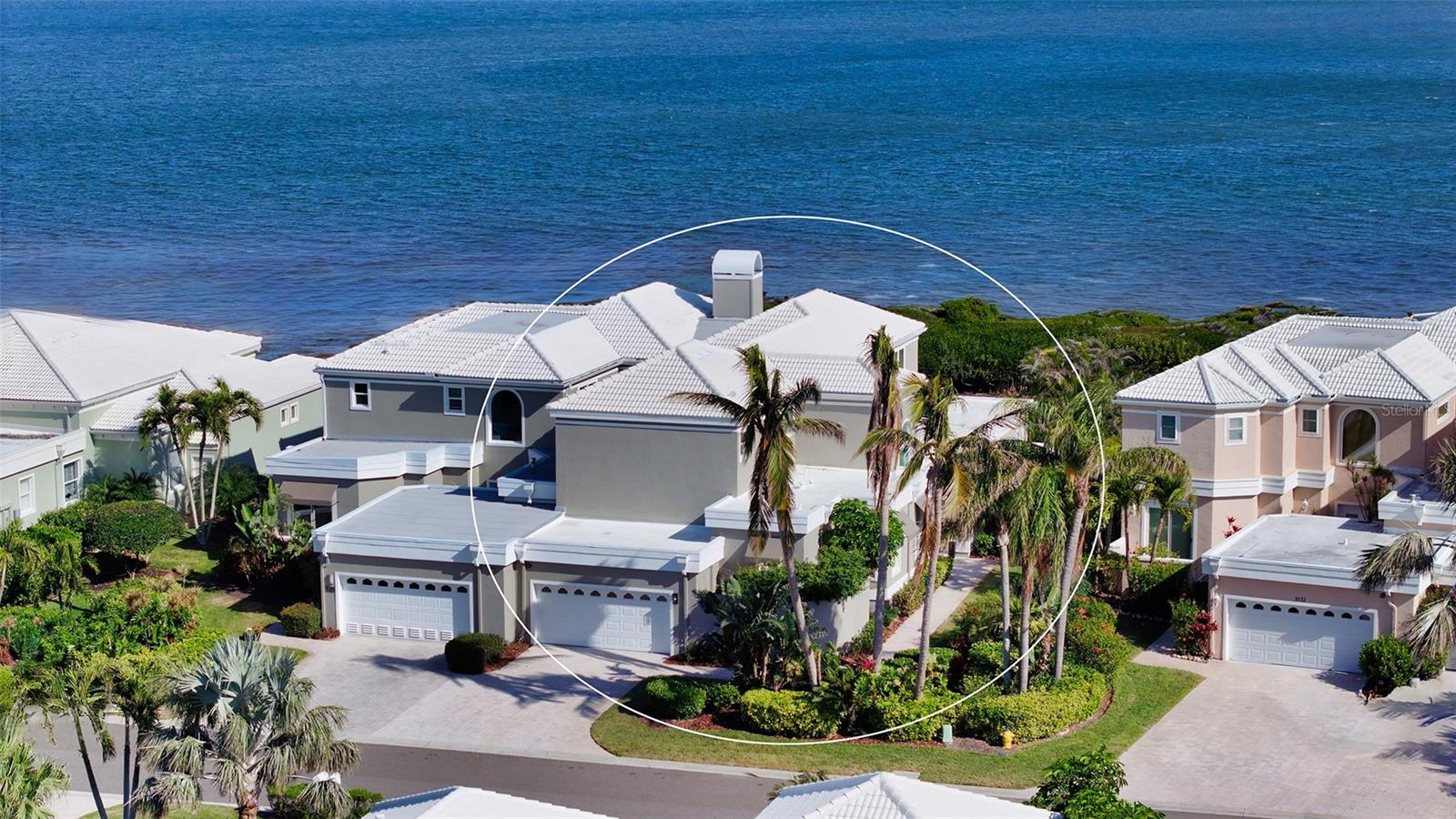 This spectacular direct bayfront four-bedroom home is offered fully furnished and meticulously updated to reflect modern coastal luxury. With sweeping views of Sarasota Bay and a deep-water dock with a lift, this residence is a boater’s dream. Every detail has been thoughtfully refined, from the new oak hardwood flooring throughout to impact-rated glass windows and sliders that flood the interiors with natural light. The home is further enhanced by freshly painted interior and exterior, a newer roof (2022), fully updated electrical and plumbing systems. Inside the nearly 3,200 square-foot layout, a stunning cathedral ceiling soars above the living area, where a statement piece fireplace and custom-built shelving add warmth and character. Floor-to-ceiling glass sliders lead to the expansive bayfront pool deck, seamlessly blending indoor and outdoor living. The state-of-the-art kitchen is a chef’s delight, featuring a waterfall-edge island with seating, quartz countertops, brand-new high-end appliances, custom shaker cabinetry with glass cutouts, a designer tile backsplash, and elegant pendant lighting. The reimagined two-story layout places the primary suite in a premier bayfront position, with sliding glass doors opening directly to the patio. The en-suite bathroom is a spa-like retreat, boasting a soaking tub, glass-enclosed shower, and contemporary finishes. A secondary guest suite and a versatile bedroom (currently utilized as a den) with dual closets complete the main level, offering ample space for work or relaxation. Upstairs, overnight visitors will appreciate the privacy of an additional guest suite enhanced by its seclusion and stunning water views. Outdoor living is exceptional, with a brand-new summer kitchen, newer heated swimming pool, and a generous pavered deck—ideal for soaking in the breathtaking bay breezes. A walk-down leads to the private dock, where direct access to Sarasota Bay and the Gulf of Mexico awaits. Corey’s Landing offers an exclusive maintenance-free lifestyle within the secure gates of Longboat Key’s exclusive Bay Isles community. Steps from your front door, enjoy the community’s tennis courts for a friendly match or head across the street to the heated pool and spa, perfect for unwinding or socializing with neighbors. Residents also enjoy private access to the Bay Isles Beach Club, where pristine Gulf beaches provide a serene escape, just a bike ride or sunny walk away. World-class dining, boutique shopping, and cultural attractions. St. Armands Circle, Lido Beach, and downtown Sarasota are all within easy reach, making this an unparalleled opportunity to experience the best of coastal living.