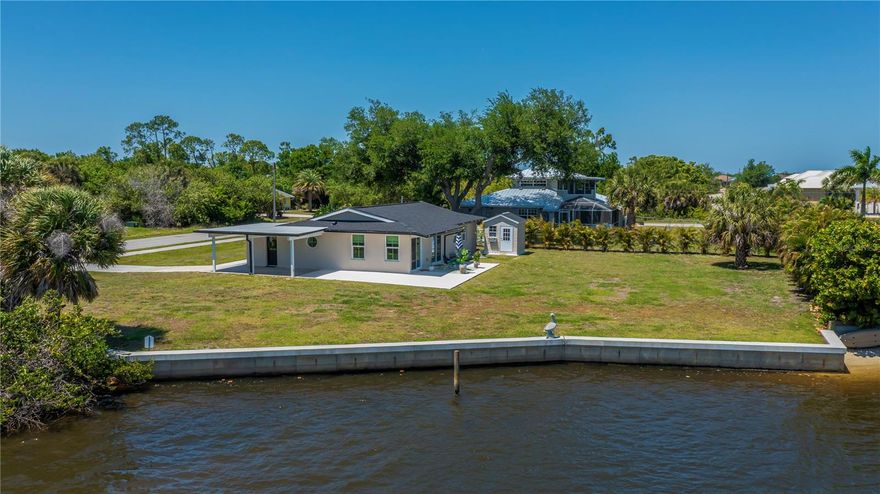 Experience the ultimate in SERENE saltwater lake living with one of a kind breathtaking panoramic Lake Views views with quick GULF ACCESS in this beautifully renovated 2-bedroom, 2-bath home, perfectly nestled on an OVERSIZED lot almost HALF AN ACRE with no HOA! Featuring a brand-new 108-foot FULL CONCRETE POURED SEAWALL 2023 (100K Value), this stunning residence sits adjacent to the highly sought-after, newly built Springview Estates and their spectacular Key West-style homes. Looking beyond the sparkling water is a natural island adding an extra special chance to experience  nature up close and personal. This 2-bedroom 2-bath home is a GEM for seasonal escapes, year-round living, or Airbnb, offering incredible flexibility including an opportunity for RV parking, maybe casita, or the perfect spot to add a pool—complete with ultimate privacy thanks to the adjacent neighboring  Spring Lake Park, nature preserve, sidewalks, public boat ramp and scenic boardwalks. NEW ROOF 2023. NEW AC 2024.

Step inside to a spacious, light-filled living room with seamless indoor-outdoor flow through double sliders that open to capture magical Florida sunsets overlooking the three dimensional  sparkling saltwater vistas from your own covered patio. The kitchen dazzles with updated stainless appliances, elegant quartz counters, raised paneled cabinetry including extra open shelved coffee/wine area, waterfall quartz breakfast bar and top-tier lighting and decorator hardware—ideal for entertaining friends and family. Luxury vinyl flooring creates a wonderful coastal vibe throughout with a side entry mudroom that boasts a wine cooler/beverage area and adds another gorgeous serving/storage area. Style, Comfort and move in ready!

The split-bedroom floor plan centers around a zen-inspired primary suite featuring a walk in dressing room with spa shelving, and a luxurious  ensuite bath with dual sinks and well designed walk in shower. The second guest bedrooms is generously sized, neutral toned colors, and outfitted with a stylish ceiling fan and a generous closet, perfect for welcoming visitors to unforgettable stays sharing an upscale modern middle bath with the rest of the home.

Additional perks include three panel wood doors, zebra blinds, inside laundry with extra storage, outside shed, NEW HURRICANE IMPACT RATED WINDOWS AND DOORS THROUGHOUT, tandem 2 car carport and tasteful outdoor lighting for added ambiance and security.

Located near vibrant recreational parks, exceptionally quick BEACH/HARBOR/ GULF ACCESS, and Meadow Park School, this home offers the perfect blend of peaceful wide lakeside charm and everyday convenience, BRING YOUR FISHING POLES, toys, hammocks and unwind where  every day is a vacation right here at home. Just minutes from Port Charlotte Beach—a favorite biking destination with a boat ramp, bocce and horseshoe pits, tennis courts, volleyball, playgrounds, a boardwalk, fishing pier, picnic pavilions, a rec center, and dog-friendly areas—all set against jaw-dropping sunsets!

Close to historic downtown Punta Gorda, the luxurious Sunseeker Resort, dining, farmers markets, festivals, Punta Gorda Airport, shopping, and so much more, this move-in-ready GULF ACCESS home with stunning saltwater lake views promises a lifestyle of relaxation and endless enjoyment.

Don’t miss out on this extraordinary opportunity! Schedule your private tour today and start living your dream!