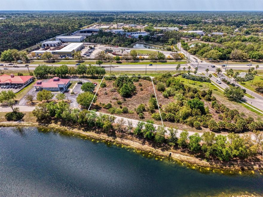 Prime opportunity in the fast-growing city of North Port, Florida! This outstanding commercial lot offers high visibility and strong daily traffic, making it a powerful location for your next project. Positioned right in the heart of North Port, this one-acre parcel stands out with a peaceful pond view that adds a touch of natural beauty to a busy commercial setting. Surrounded by thriving businesses, this property sits in a highly desired commercial area where growth continues year after year. The steady flow of vehicles passing by each day provides excellent exposure and brand presence. This is the kind of location that puts your business in front of the right eyes, every single day. A major bonus—Morris Engineering & Surveying has already completed groundwork for a 12,000 sq. ft. auto body building, saving valuable time and effort in the development process. This head start makes it easier to bring your vision to life faster and more efficiently. With North Port experiencing rapid commercial expansion, opportunities like this are becoming harder to find. The combination of location, traffic, and preparation makes this property a standout investment in Southwest Florida real estate. Secure this high-potential commercial lot today and take advantage of everything North Port has to offer. Make your offer now before it’s gone!