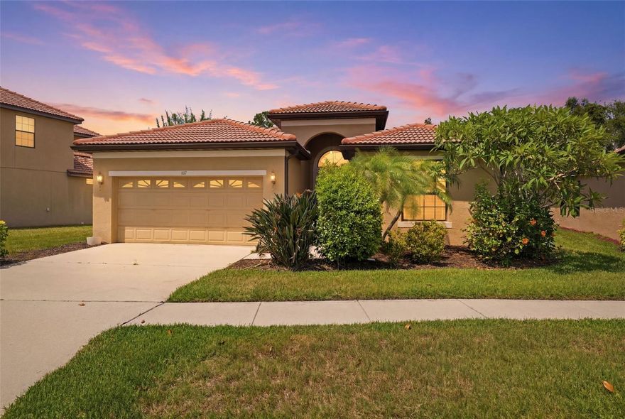 Short Sale. Blending timeless Mediterranean elegance with comfortable Florida living, this beautifully maintained residence sits on 0.14 acres and welcomes you with tropical landscaping, a tile roof, and a grand covered entry highlighted by soaring ceilings, an arched transom window, and a private courtyard-style front porch. Inside, the home showcases an airy open-concept design filled with natural light, elegant architectural archways, crown molding accents, ceramic tile flooring, and spacious living areas designed for both entertaining and everyday comfort. At the center of the home, the beautifully appointed kitchen offers rich wood cabinetry, granite countertops, stainless steel appliances, tall upper cabinets, and an expansive breakfast bar with integrated sink and seating, all flowing seamlessly into the dining and living spaces. The bright breakfast nook, surrounded by large windows and peaceful outdoor views, creates the perfect place for casual dining, while the formal dining room adds warmth and sophistication with chandelier lighting and open flow into the main gathering areas.  The spacious family room and open living room are filled with natural light and enhanced by elegant window treatments, creating inviting spaces ideal for relaxing or entertaining. Large French doors in the living room provide seamless indoor-outdoor flow to the lanai and pool area, adding to the home’s airy and open feel. The spacious primary suite serves as a relaxing private retreat featuring rich wood flooring, tray ceilings with crown molding, large windows, and a dedicated hallway lined with dual-sided closet storage. The luxurious en-suite bathroom offers dual granite vanities, abundant wood cabinetry, a seated makeup station, decorative architectural accents, a private water closet, and a beautifully tiled walk-in shower that delivers a spa-inspired atmosphere. Bedroom two offers warm wood flooring, abundant natural light, elegant drapery, and a spacious double-door closet, while bedroom three continues the warm and inviting design with stylish window treatments and practical storage. The second bathroom features granite countertops, wood vanity cabinetry, tile flooring, and a convenient tub and shower combination. A versatile office room with French doors provides flexibility for a home office, den, hobby room, or guest space. Step outside into your own private outdoor retreat featuring a spacious covered patio, screened lanai, and sparkling in-ground pool surrounded by lush greenery and mature landscaping. The expansive pool deck and peaceful backyard setting create the ideal space for entertaining guests, relaxing in the Florida sunshine, or enjoying quiet evenings with serene tropical views. Additional highlights include a functional laundry room with direct garage access, built-in storage shelving, and thoughtfully designed spaces that combine timeless style, comfort, and everyday functionality throughout the home.