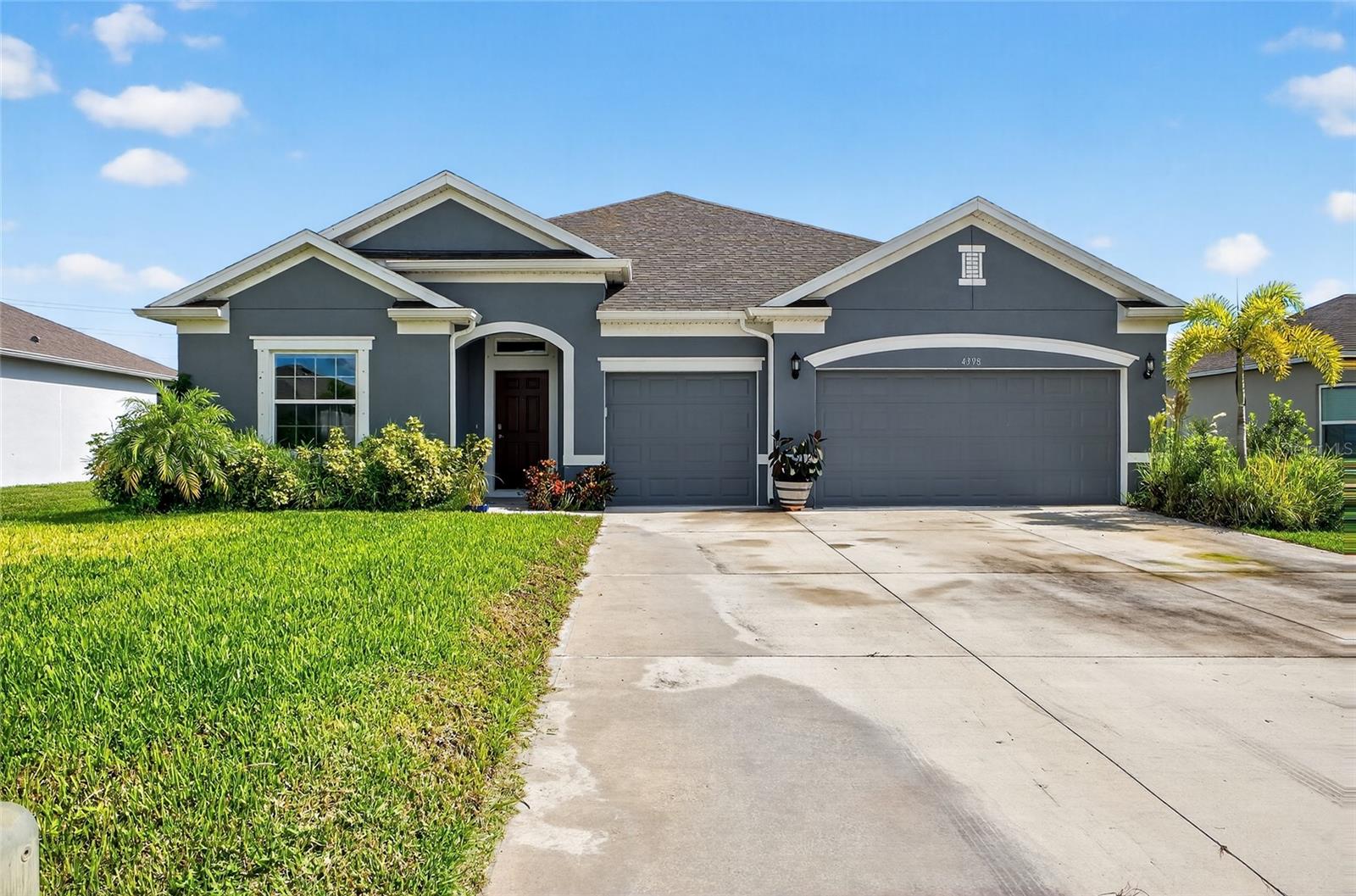 Welcome to this stunning 4-bedroom, 3-bath residence with a spacious 3-car garage, perfectly situated on a tranquil lake in beautiful Micco, Florida. Built by Holiday Builders, this home combines thoughtful design with comfort and style. Step inside to soaring 12-foot vaulted ceilings that create a bright, airy atmosphere throughout. The open floor plan offers seamless flow between living spaces, ideal for entertaining or everyday living. Home also boasts an office/den that could be used to convert into a 5th bedroom if desired. New water softener in garage as well. Every detail has been considered, including blackout blinds installed throughout for privacy and energy efficiency, gutters for easy maintenance, and hurricane shutters for added peace of mind. The kitchen and living areas capture serene water views, while the split-bedroom layout ensures comfort for family and guests. Outdoors, enjoy a private backyard retreat with lush banana trees and room to relax by the lake. Whether sipping coffee on the patio, hosting a barbecue, or simply watching the sunset over the water, this home offers the perfect blend of natural beauty and convenience. This is your chance to own a well-appointed lakefront property in Micco with modern features, strong construction, and true Florida charm. This quaint community near the St. John's Buffer Preserve but yet is convenient to all the necessities & leisure activities you desire: boating, fishing, the beaches, the Sebastian Inlet. Call today for a private tour.