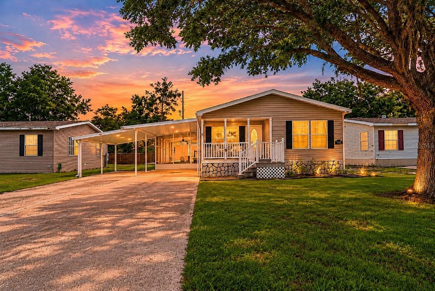NO HOA & YOU OWN THE LAND! This beautifully maintained and thoughtfully upgraded home offers approximately 1,650 square feet of comfortable living space (under air) and an incredible amount of indoor and outdoor functionality. 
One of the standout features of this property is the enormous screened Florida room — a space rarely found at this size. Complete with durable epoxy flooring, functional privacy screens, and double-door access, this versatile area is ideal for entertaining, enjoying your morning coffee, hosting family gatherings, or simply embracing Florida's beautiful weather year-round.
From the moment you arrive, you'll appreciate the charming covered front porch, extended driveway with parking for multiple vehicles, and the massive two-car carport that provides exceptional convenience for homeowners and guests alike. The home's upgraded skirting not only enhances curb appeal but also allows for easy crawlspace access and maintenance. The roof was replaced in 2020!
Inside, you'll find an inviting open-concept floor plan filled with natural light and enhanced by upgraded luxury vinyl plank flooring throughout. The spacious living area features a cozy wood-burning fireplace, creating the perfect gathering space for relaxing evenings at home. The kitchen is designed with both style and practicality in mind, showcasing beautiful granite countertops, an induction cooktop, extended cabinetry for additional storage, and ample workspace for preparing meals and entertaining guests.
The primary suite includes a massive walk-in closet and generous living space, while the sizable indoor laundry room provides additional storage and everyday convenience.
Outside, a well-maintained storage shed with ramp access provides the perfect place for tools, lawn equipment, hobbies, or seasonal décor. Every aspect of this property has been carefully maintained, making it truly move-in ready.
Located in a friendly and peaceful community, you'll enjoy convenient access to shopping, dining, medical facilities, major highways, Orlando attractions, and Florida's beautiful beaches without the hassle of HOA fees. 
If you've been searching for a home that combines functionality, modern updates, and a great location at an affordable price, call us today to schedule your private showing!