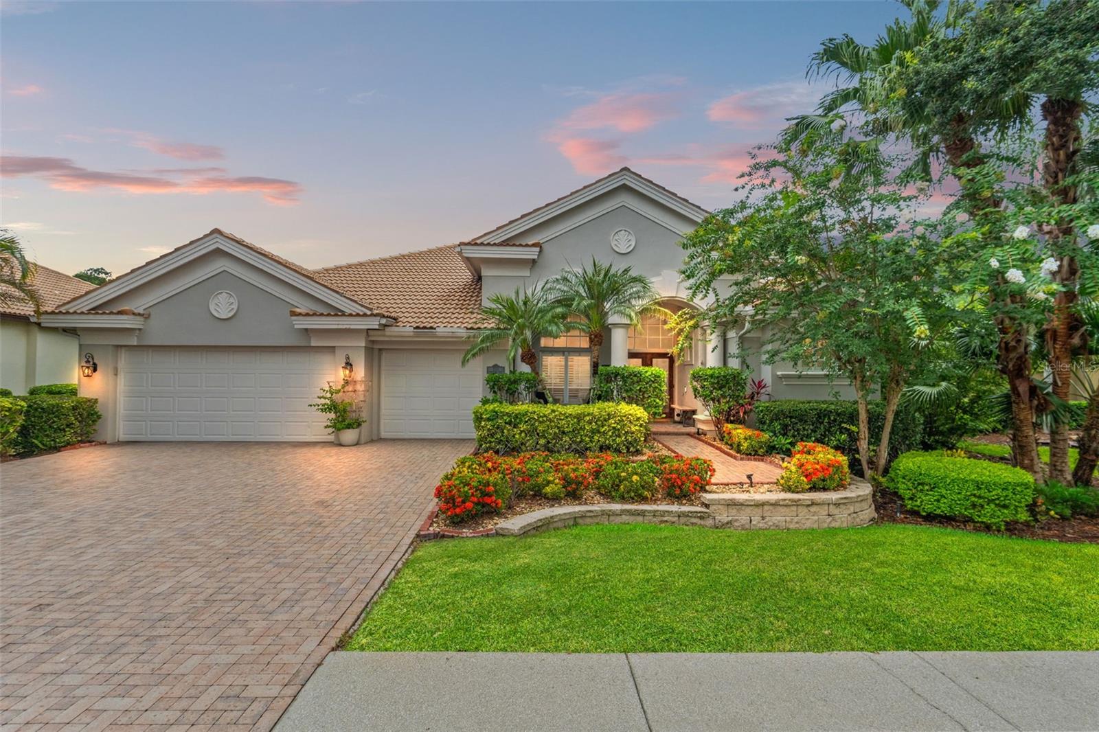 Stunning Marc Rutenberg-Designed Executive Home in Gated Community
Welcome to your dream home—an exquisite Marc Rutenberg-designed residence nestled in a private, gated executive enclave. From the moment you arrive, the brick-paved driveway and charming front patio set a tone of elegance and warmth that continues throughout.
Step through grand double wood and leaded-glass doors into a sunlit interior with immediate views of your own private resort-style oasis. The screened lanai boasts a sparkling electric-heated pool, natural gas spa, and a covered lounge with awning—perfect for entertaining or unwinding under the stars.
Inside, the sophisticated three-way split floor plan features formal living and dining areas with 11 ft ceilings, an open-concept kitchen with rich wood cabinetry, granite countertops, stainless steel appliances, and a wine fridge—all anchored by a stunning double-sided fireplace shared with a bright and versatile bonus room.
The luxurious master suite is a true retreat, offering French door access to the lanai, a spa-inspired bath with dual sinks, soaking tub, oversized dual-head shower, and a show-stopping custom walk-in closet. Secondary bedrooms include a Jack-and-Jill suite and a private guest room with pool access—ideal for multigenerational living.
Additional highlights include a full-home sound system (including lanai), abundant custom closet space, plantation shutters throughout, and an oversized 3-car garage. Recent upgrades: new A/C (2018) with Nest thermostat, water heater (2020), and no carpet anywhere. The fully fenced yard offers privacy without compromising views—and best of all, no flood insurance required.
Located minutes from top-rated schools, beautiful beaches, parks, dining, and shopping—this home is the perfect blend of timeless design, modern upgrades, and Florida resort-style living.
This isn’t just a home. It’s a lifestyle. Don’t miss your opportunity to make it yours.