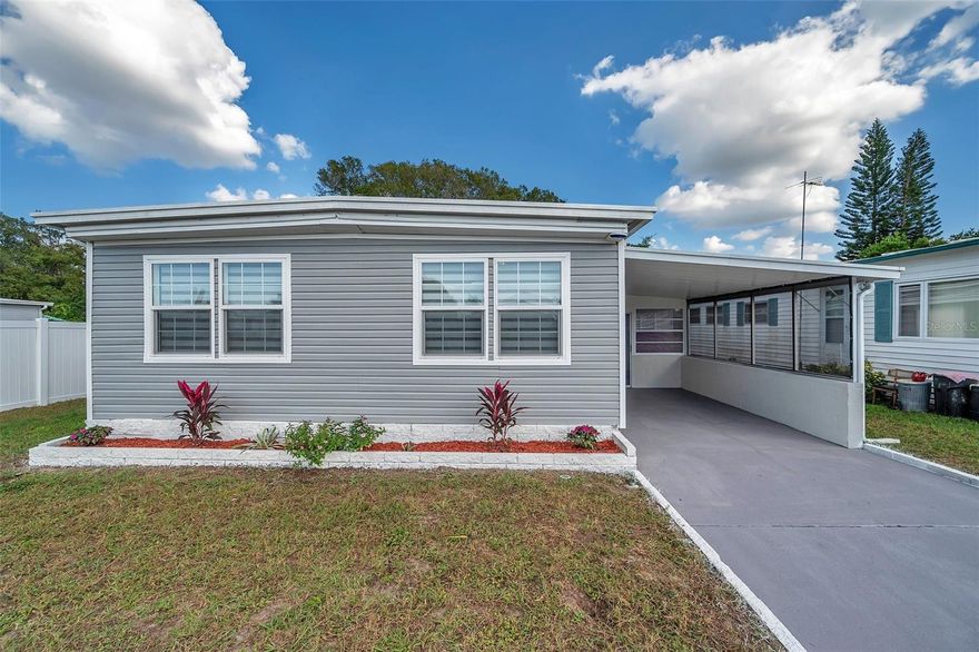 One or more photo(s) has been virtually staged. WELCOME TO YOUR AMAZING HOME at 2326 Prestige Dr, Holiday, FL in the SUPERB 55+ community of Buena Vista Manor. This 1973 MARVELOUS 3 bedrooms + Florida room, 2 bathrooms, double-wide mobile home lies on a WONDERFUL lot with 4116 sqft in a NO CDD or NO FLOOD zone & LOW HOA of $200/year. Key exterior features are covered carport parking, storage shed, open patio in the back yard with NO REAR NEIGHBORS, rain gutters, private mailbox, raised garden bed & easy breezy TROPICAL landscaping. When you step inside, you'll LOVE the OPEN FLOOR PLAN consisting of the kitchen, dining, living & family rooms & MAGNIFICENT FLORIDA room. This MASSIVE Florida room with dimensions 38' x 12' has plenty of windows laid upon block construction, carriage light, painted concrete floor & entrance into the home through a set of double glass sliding doors. The RENOVATED kitchen features a stainless steel double sink with gooseneck faucet, SOLID WOOD cabinets with hardware, expansive laminate counters, tile backsplash, pantry closet, breakfast bar & nice appliances. The renovation continues into the dining room with CRYSTAL chandelier while the large family room features a wall shelf perfect for displaying family photos. The living room has a pair of lighted wall sconces, BRAND NEW luxury vinyl floors (installed after the photos were taken) & access to the FL room. All the floors are ELEGANTLY dressed with water resistant laminate or luxury vinyl planks & porcelain tiles in the bathrooms (NO CARPET ANYWHERE)! Natural sunshine streams through the DOUBLE-PANE, ENERGY EFFICIENT, THERMAL-TINTED, LOW E INSULATED WINDOWS ILLUMINATING the interior together with the BRIGHT light fixtures. The primary bedroom can fit king size furniture & has a private bathroom, walk-in closet & MODERN ceiling fan/light. The REMODELED primary bathroom features a step-in shower with glass enclosure, newer toilet, vanity with GRANITE counter & shaker-style cabinet doors, linen closet & round mirror attached to a beautifully tiled accent wall. The second & third bedrooms are similar in size & have walk-in closets! Additionally, the 3rd bedroom has 2 entrances into this room - through a set of double glass French doors from the family room or through an interior door from the hallway. The REMODELED bathroom is refined with TIMELESS cabinet with QUARTZ counter & satin nickel faucet, triple glass pendant lights, newer toilet & tiled shower with grip handles for added safety. The laundry washer & dryer machines are included in the sale. SWEET interior improvements include high-end zebra custom rolling window blinds on some of the windows, new smoke detectors & drywall interior versus manufactured home paneling. More SUPERIOR DETAILS include newer vinyl siding, new vapor barrier, well irrigation for landscaping, brick base around the home to prevent unwanted critters & chain link fence along the back perimeter. The roof is sturdy metal, the AC is cooling fabulously & the water heater is pumping out hot water. There is NOTHING to do in this home as it is TRULY MOVE-IN READY & available for INSTANT ENJOYMENT OF THE LUCKY NEW BUYERS! Buena Vista Manor is a SWEET community where PETS ARE WELCOME! Included in the HOA fee are recreational activities like shuffleboard & clubhouse where many social activities take place. Location is IDEAL near beaches, shopping, restaurants, medical plazas, places of worship & tourist attractions. MAKE THIS YOUR FUTURE HOME!
