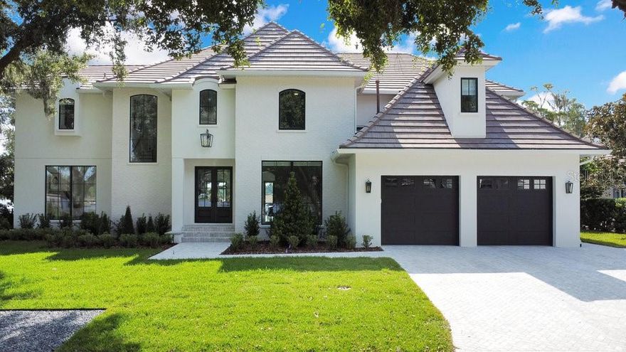 Welcome to 12 Pine Street in downtown Windermere, where you will have endless sunkissed mornings and sunsets bathing you at golden hour. Pine Street is a picturesque peninsula lined with mossy oaks and is one of the few paved roads in town. This impeccably remodeled home is situated on a rare lakefront lot with tranquil water views from nearly every room. Take a dip in your newly remodeled splash pool and spa, and enjoy the breathtaking views of Wauseon Bay from your patio. No expense was spared while remodeling this custom-built Stonebridge Homes estate. The professionally designed interior includes new custom cabinetry and countertops in the kitchen and bathrooms, incredible millwork, solid oak flooring, marble tile, and artfully chosen fixtures throughout. The primary bedroom with a postcard-worthy panoramic water view, stunning bathroom, and dual closets are pure luxury. All en-suite bedrooms have been tastefully remodeled including the ground-floor guest suite, a special space with lake views from the front and back. The natural gas fireplace was re-faced with beautiful limestone brick, and the exterior surfaces were completed with smooth stucco and brick accents. The tile roof, HVAC, and water heaters were upgraded within the past 36 months, and new windows, doors, and garage doors were installed this year. Plan to do some entertaining while taking advantage of your brand-new summer kitchen, while enjoying designer landscaping and water views, all from the lanai. Then take the boat out to Bird Island and enjoy everything the renowned Butler Chain of Lakes has to offer. Or enjoy a peaceful stroll to Windermere’s eclectic shops, brewery, and more. Schedule your private showing of this coveted lake home today.