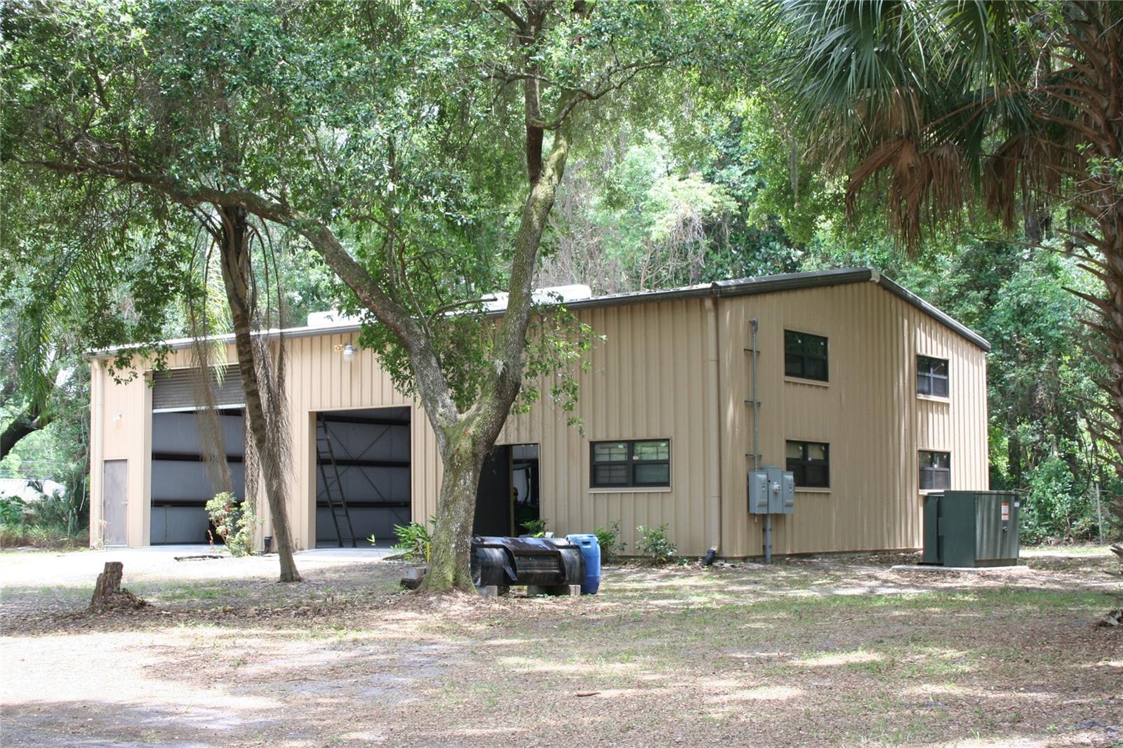 Beautiful, park like acreage extends from Hwy 17 through to Old Hwy 17 has a 40x60 Metal Building and original old house. The metal building includes a 2nd story mezzanine, 2 large roll up doors, 3 metal walk through doors/windows, 2 baths, hot water heater, shower can be added. LED lighting, 3 Phase 208 electric in building and preinstalled on 3 other above ground locations on property for future building. The property also has 3 wells, irrigation, is fenced/security.
Agricultural zoning keeps taxes low while the building is approved for manufacturing use. Property location is just before downtown Crescent City, a historic waterfront on large Crescent lake that leads to the Atlantic Ocean.
Any other questions call broker
