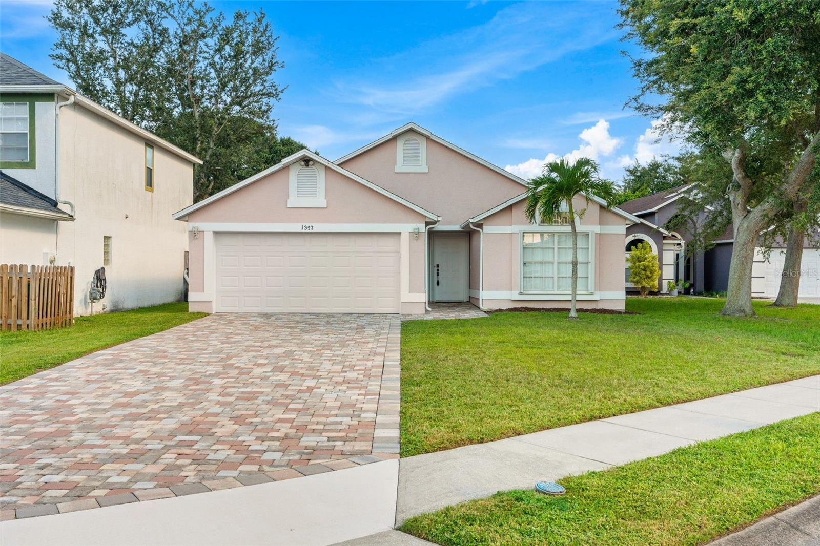 Welcome to 1327 Cypress Bend Circle. This lovingly maintained home anxiously awaits its new owner. Upon arrival, you will be greeted by a custom brick paver driveway that offers not only an elevated aesthetic but also a great deal of off street parking in addition to that offered by the attached garage. The exterior of the home also blends function and style with a neutral toned color scheme and windows adorned with hurricane shutters. As you step inside, you are welcomed within by vaulted ceilings and the same neutral color scheme as outside. The floor plan makes the most of every inch. The guest bedrooms are privately tucked away off the entry and share a graciously appointed bathroom. The bedrooms themselves also offer a great deal of space and storage. Their location offers a great deal of functionality and privacy for the primary bedroom. The heart of the home features the elevated ceilings, again. The spaciousness will certainly be enjoyed by both visitors and residents alike. The kitchen design allows for the chef of the home to still be involved with what is happening in the attached living area while not sacrificing wall space for cabinetry by doing so. You will find all of the counter and cabinet space you need here. The main living area offers an abundance of natural light and a view of the private back yard. This lovely level lot has been enhanced with a privacy fence that helped to create the perfect oasis. Whether you spend your time enjoying the covered back deck or working in the yard, this home offers both options for enjoyment! Last, but not least, you will find the primary retreat. The rooms expanse is complimented by the same high ceilings we have come to enjoy throughout the rest of the home. From the closet space to attached primary bath, you are sure to be impressed with the sheer space offered within a home of this square footage. The home has been priced aggressively. We encourage you to schedule your tour soon!