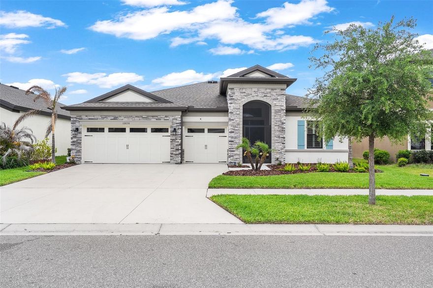 This beautifully upgraded 4-bedroom, 3 bath Bayshore model with dedicated office and 3-car garage blends thoughtful design, upscale finishes, and effortless indoor-outdoor living in one of Hawkstone’s most desirable settings. Perfectly positioned on a premium pond-view homesite, the home captures peaceful water views from the expansive screened lanai, sparkling pool, and relaxing spa — creating a private backyard retreat designed for both entertaining and everyday living. Inside, the split-bedroom floor plan offers exceptional functionality with spacious open living areas, abundant natural light, and seamless flow throughout. Large sliding glass doors frame the outdoor living space while bringing the water views directly into the heart of the home. The extended chef’s kitchen serves as the centerpiece of the residence, thoughtfully designed with a massive center island, butler’s pantry, natural gas cooktop with pot filler, abundant cabinetry, and generous prep and storage space ideal for gatherings both large and small. Plantation shutters, automatic shades over the sliding glass doors, upgraded finishes, and carefully selected details create a clean, timeless feel throughout. The spacious primary suite offers a peaceful escape with dual walk-in closets and a spa-inspired bath featuring split vanities, a soaking tub, walk-in shower, private water closet, and linen storage. Additional upgrades include StormTex hurricane screens installed by Roll Shield, epoxy-coated garage floors, tankless water heater, whole-home water treatment system with prepaid annual maintenance, and smart, energy-efficient features throughout. Located within the highly sought-after Hawkstone community, residents enjoy access to resort-style amenities including a lagoon-style pool, splash pad, playgrounds, pickleball courts, bocce ball courts, dog park, and scenic walking trails. Conveniently situated near US-301 and I-75, with close proximity to Triple Creek Nature Preserve, Lithia Springs Park, Fish Hawk Creek Preserve, shopping, dining, and top-rated schools, this home offers the perfect balance of luxury, comfort, and Florida lifestyle living. Hurry here is your chance to own this impressive pool home with incredible finishes and impressive waterfront views