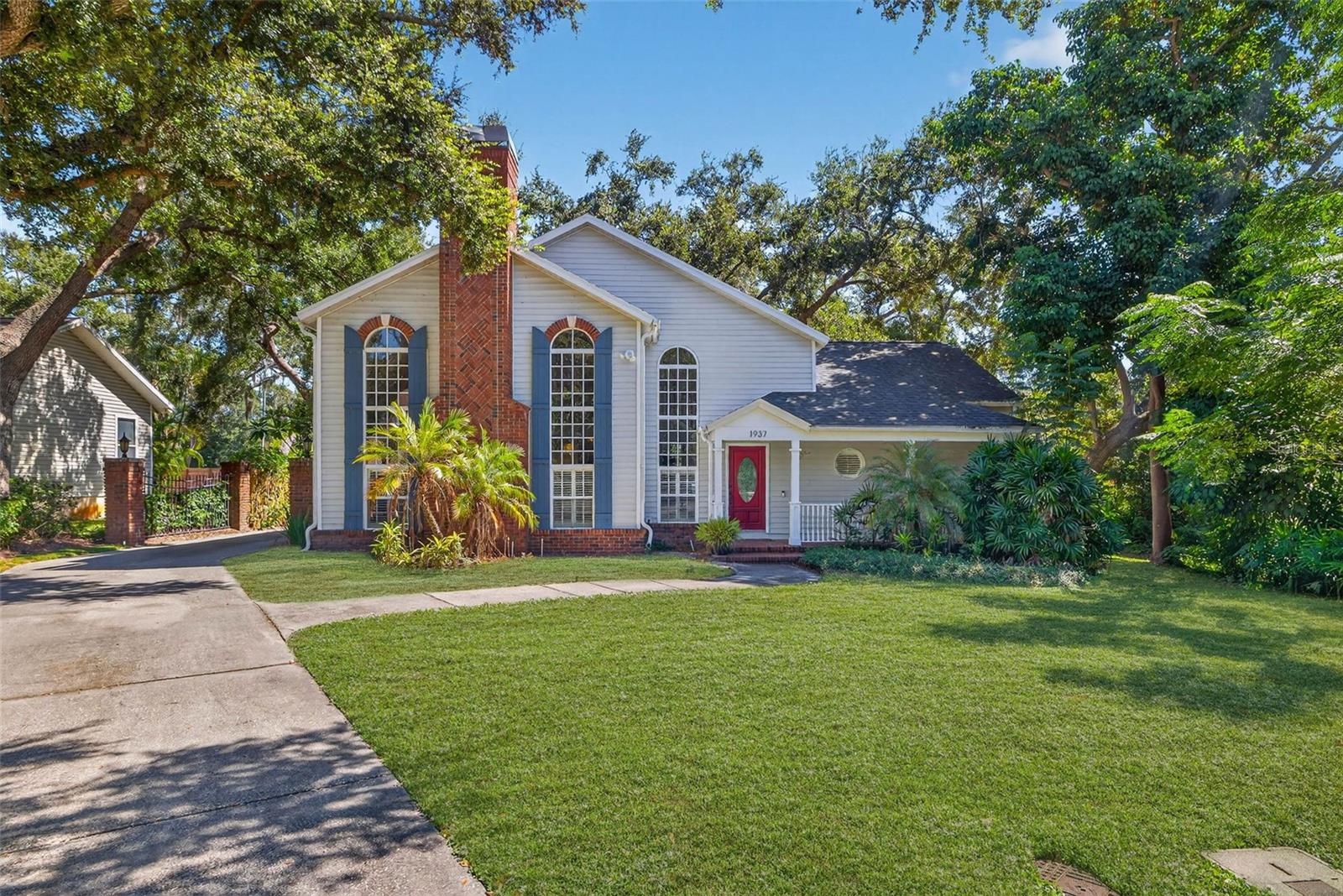 Welcome to 1937 Oakridge Court, a hidden Clearwater retreat perfectly positioned on nearly 1/2 acre in a quiet cul-de-sac beside a peaceful creek. This beautifully maintained 3-bedroom plus bonus room, 2.5-bath home combines modern comfort with timeless character, featuring soaring 20+ foot vaulted ceilings, and a roof top deck for enjoying treetop views and Florida sunsets. Some other amazing features of the home include luxurious bamboo flooring, a wood-burning fireplace that anchors the light-filled living space. The open kitchen showcases granite countertops, shaker cabinetry, Frigidaire stainless steel appliances, under-cabinet lighting, and a reverse osmosis water system, while smart lighting, a Honeywell thermostat, and a Ring security system bring convenience and peace of mind. The ground-floor primary suite offers a custom reading nook, double vanity, walk-in shower, and custom closet systems, while upstairs features two additional bedrooms with a Jack-and-Jill bath, and of course the rooftop deck. Every detail of this property reflects care and quality, from the Rheem HVAC (2025), shingle roof (2018), and 50-gallon water heater (2018) to the Amana washer and dryer (2018), Rain Bird irrigation system, and hardwired speaker setup. With crown molding throughout, a covered front porch, oversized yard, and furnishings negotiable, this home delivers comfort, style, and functionality in one exceptional package. Conveniently located near top-rated schools, shopping, dining, and Clearwater’s award-winning beaches, 1937 Oakridge Court offers the rare combination of privacy, space, and sophistication — the perfect place to call home.
