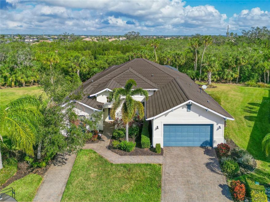 Welcome to Your Elegant, Maintenance-Free Home in Tidewater Preserve! Experience luxury living in this stunning, move-in ready home located within the 24/7 manned gates of Tidewater Preserve, a popular boating community. If you're searching for a resort-style lifestyle, look no further! As you approach, brick pavers lead you to the front door, welcoming you into a home with soaring ceilings and an open-concept floorplan. The great room features tray ceilings and multiple sliding doors that seamlessly blend indoor and outdoor living. The dining area also has a tray ceiling and is open to great room. Beautiful travertine tile flooring extends throughout most of the home, adding to its elegance. Built in 2012, this home boasts incredible upgrades, including: 3 Bedrooms + Den (4th Bedroom), 3 Bathrooms, 3rd Smaller Garage, Storm Impact Windows, Ceiling Fans & Special Lighting Fixtures, Custom His and Hers Closets, Fabulous Granite Countertops, New AC (2021) 42” Solid Wood Cabinetry with Glass Fronts, Newer Water Heater, and Upgraded Gas Appliances. The spacious primary bedroom features a tray ceiling, a door to the pool area, and large his and her walk-in closets. The primary bathroom offers a sunken tub, a fabulous shower, and dual sinks with quartz counters. Outdoor Living at Its Finest: Step outside to your own private oasis! The wonderful resistance pool is perfect for fitness enthusiasts, while the Kevlar storm screen and brick pavers add functionality and protection. Situated on a cul-de-sac lot, this home offers space, privacy, and a picturesque backdrop of lovely palm and oak trees, making you feel as if you are in a park. The oversized yard can be completely fenced for pets and provides convenience for pet owners. Additionally, the exterior features an outdoor movie theater, perfect for entertaining family and guests. Resort-Quality Amenities: Tidewater Preserve is a guard-gated community offering resort-quality amenities, including: Private Marina with electronic Lift & Access to Manatee River/Gulf via lock system. 2 Clubhouses, 2 Fully Equipped Fitness Centers, Beach Entry Pool, Har-Tru Tennis Courts, Dog Park & Playground, Kayak & Canoe Launch, and Nature Trails Along the River Enjoy the vibrant lifestyle of Tidewater Preserve, conveniently located near Lakewood Ranch, Sarasota, and world-class beaches. Boat slips are available for rent, and management can assist after closing. With low HOA fees and no CDD, this home is the perfect gateway to the Florida lifestyle you've been dreaming of.
