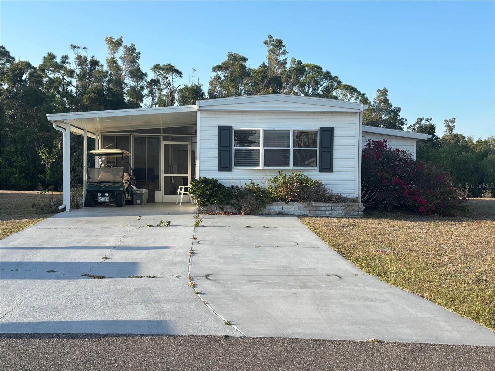 Welcome to the friendly WATERFRONT COMMUNITY, Village of Holiday Lake. You will love this FURNISHED, TURNKEY 2 bedroom, 2 bathroom with a BONUS ROOM. Here you’ll find an eat-in kitchen overlooking your living room area with sliders out to the air conditioned Bonus Room. Nice size master bedroom with large double closet with a full master bath. An additional spacious bedroom is awaiting visiting friends and family along with a private bathroom with walk-in shower. This property also has a lanai as you enter from the carport. ROOF 2023. Property does need some work. Includes the GOLF CART which will need batteries. There is always something going on for everyone at the large recreation hall with full kitchen, craft room, laundry facility along with areas for woodworking, FITNESS CENTER, tennis, PICKLEBALL, shuffleboard and more. Here you will enjoy some of the areas finest GOLF COURSES all within 5 miles. The outdoor enthusiast in you will love the closeness of boating and fishing from the COMMUNITY DOCKS and boat ramp. GULF ACCESS. You will also find several Gulf Shore Beaches close by. The foodie in you will love the local delights like Gerry’s Tiki Hut, Farlow’s on the Water and the Sandbar Tiki & Grill to name a few. Perfect for year round living or a winter get away spot. Your chance to own your own piece of paradise!