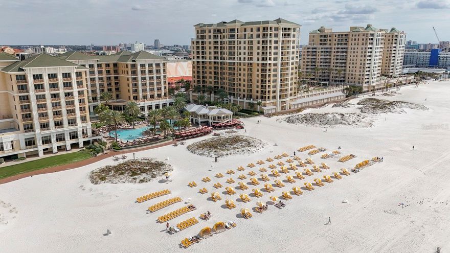 Welcome to the Residences at Sandpearl Resort, the epitome of luxury living on Clearwater Beach. Updated in 2023, this 9th floor, 2 bedroom, 2.5 bathroom plus flex space condominium, features a North and West picturesque view of Clearwater Beach. The 2 bedrooms provide en-suite bathrooms and there’s a half bath for guests. The primary bath was upgraded with quartz countertops, the 2nd
bath updated to a walk-in shower, with quartz countertops and new plumbing fixtures, and the half bath upgraded with refinished cabinets. The flex space can be used as a den, an office or extra bedroom. The kitchen was updated with refinished cabinetry, quartz countertops, a new dishwasher, Pentair water filtration system and Frankie hot/cold filtered water dispenser. The entire condominium was repainted, updated with new lighting and a new water heater. Appliances, HVAC and general inspections of this unit have been maintained
under a semi annual maintenance plan to ensure performance and efficiency of the unit’s operating components. There is a designated parking space and 1 guest space (based on availability) in the secured, 2nd floor garage, while guests are offered 1st floor “guest” garage parking, also based on availability. The amenities of the Sandpearl Resort are unique and endless. With 24/7 security and concierge, there is someone available to assist you at all times. The common areas include a newly renovated social room with a catering kitchen, daily coffee service, a state of the art fitness center, sauna, steam room, billiards, pool, spa, cabanas, grill area and access to the Sandpearl hotel room service. This beachfront unit provides privacy and peacefulness with it’s prime location on the North side of the building, while still providing a close proximity to vibrant local attractions, shopping, dining and entertainment options.