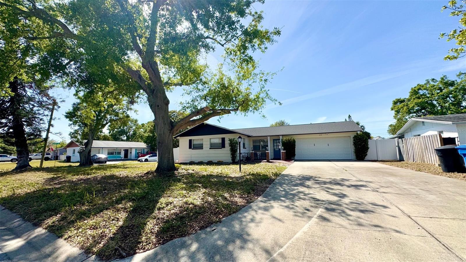 BRAND NEW FLOORING throughout this updated home!!! This Home has NEVER been flooded! Must see, HUGE CORNER LOT, Turn key spacious 4/2 open floor plan ranch style home w/ modern galley kitchen. This fully updated 4 bedroom, 2 bathroom, 2 car garage block home features many upscale renovations. The newer kitchen features updated cabinets, granite countertops, newer stainless steel appliances, huge deep sink and more! Newer shingle roof & HVAC! Both bathrooms have been updated. Wood-look waterproof vinyl plank flooring. Fresh paint inside and outside. New lighting, fans, baseboards, etc! Zoned as ADU compliant, the Seller has plans drawn-up for the storage shop in the backyard to be converted into a Guest "In-Law" Suite or potential Rental Income space with electricity and plumbing available. Also perfect for that extra storage area or could easily become the perfect "man cave", "she-shed", or recreational hangout space for the young or young at heart! This highly sought after Corner Lot has a double gate on the side of the property with a parking pad which will allow you to easily park your boat, RV, work truck, etc! Covered patio in the backyard makes for the perfect place to grill out and enjoy with family and friends. Room sizes are estimates only. Public records may not reflect the additional enclosed 315 square feet in the back Family room/Florida sun room. Large, fruit bearing "Florida Orange Tree" in the backyard. Great Home & Yard for entertaining family & friends. Custom Flooring in a Large 2-Car Garage. The deep driveway provides lots of parking space for multiple cars and guests.