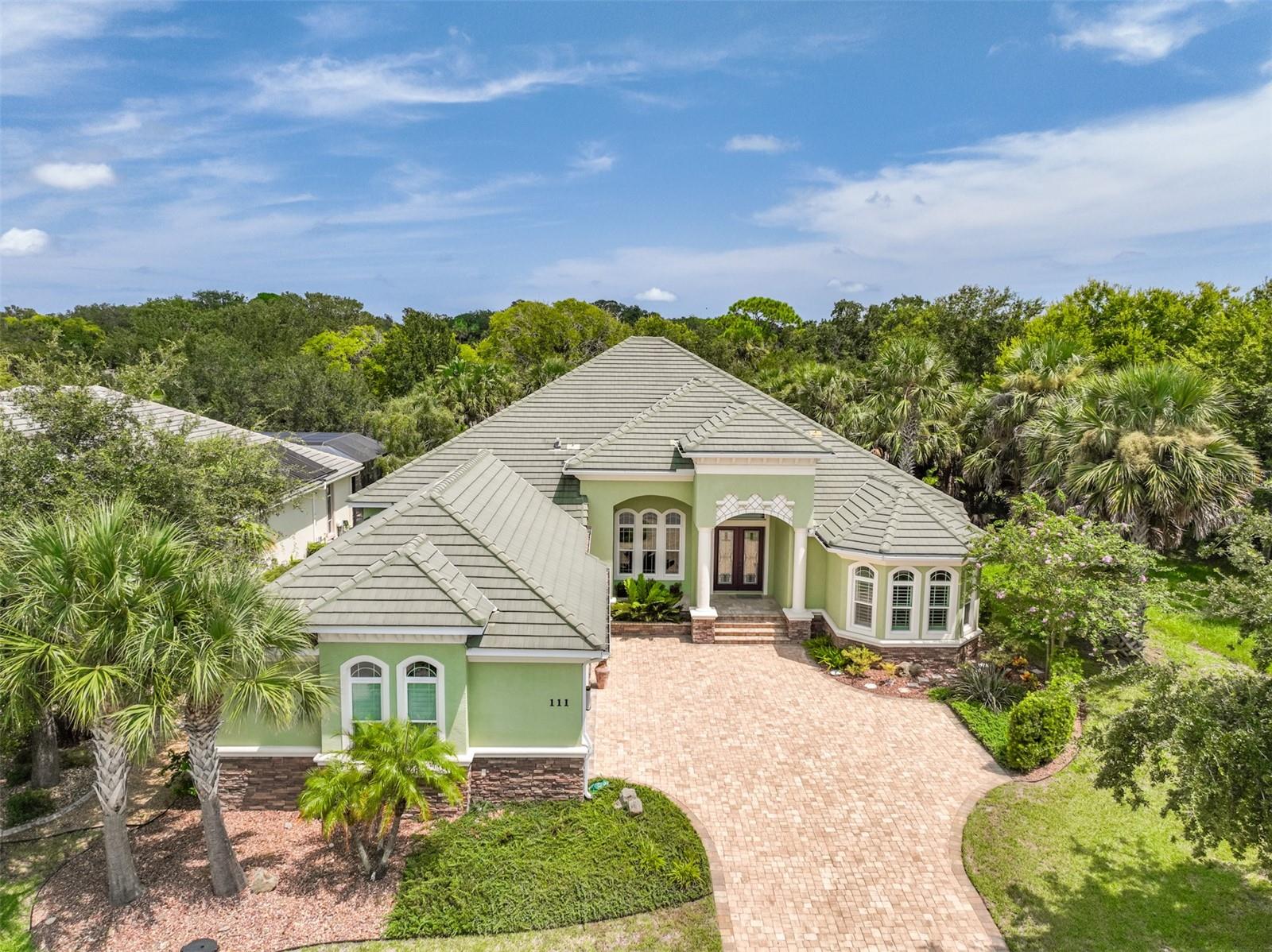 WOW !!! Like new Intracoastal Waterway home in the hidden gem of Palm Coast, the gated community of TIDELANDS ESTATES. Home sits on double lot. 160 feet of water frontage. Seawall entire length. Very immaculate. Four bedrooms plus a den. 3 1/2 baths. Jetted tub and very large double shower in primary bath. Oversized three car garage. Brick paver driveway and path. Lots of high-end cabinets and plenty countertops. Walk-in pantry. Stainless steel appliances. Summer kitchen on large spacious entertaining lanai. Beautiful Infinity pool with spa. Home sits high whereby you can see the water and boats going by. Watch the dolphins and manatees swim by. Boathouse with lift and sitting area. Also comes with a separate lift for a jet ski. Walking trail along the Intracoastal Waterway. Community Pavilion sits on the Intracoastal with screened in gazebo, outdoor sitting pier, relax with your neighbors or just FISH. Option is available to join the Clubhouse Amenities which includes two pools, exercise room, meeting room, lounge, spa, tennis. Close to restaurants, golf, boating, retail shopping, banks, doctors, city kayak launch, city bike paths. 9 minutes to the beautiful beaches. LIFE IS GRAND IN TIDELANDS !!