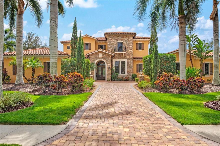 Nestled within  The Lake Club, an exclusive Tuscan-style, guard-gated community, is this custom home built by John Cannon, this custom-built residence is an embodiment of luxury. Beyond the guarded gates, a world of extravagance unfolds, inviting you to immerse yourself in the splendors of a half-acre haven that effortlessly merges with a serene lake, peaceful preserve, and a linear park . With six generously appointed bedrooms and six-and-a-half bathrooms, this home offers a lifestyle beyond compare. Double glass and wood front doors swing open, unveiling a world of aesthetic wonders. The grand family room takes center stage. Here, a gas stone fireplace, framed by custom-built shelving, stands as a masterpiece of craftsmanship. Architectural marvels continue with ceiling treatments, crown molding, and arched detailing. Enormous ten-foot sliding doors blur the line between indoor and outdoor living spaces. The kitchen is undoubtedly the heart of this home as it features granite countertops, stainless steel appliances, bespoke wood cabinetry, and a glass tile backsplash, dual Sub-Zero refrigerator and freezer, accompanied by a Wolf 48" four-burner double stove/griddle. Two generously sized pantries and an ice maker enhance the functionality of this epicurean haven. Adjacent to the kitchen, a spacious dining area, accentuated by substantial wall niches, opens onto the inviting lanai.
Retreat to the owner's sanctuary on the first floor with a sitting area invites you to relax, offering a tranquil escape from the demands of the day. The ensuite bath, adorned in marble, is a masterpiece of luxury, featuring dual sinks, a sumptuous garden tub, a vanity, and a walk-in dual shower. A capacious walk-in closet, complete with an island and built-ins, ensures that organization and storage are never a concern. Two additional closets and a storage area provide ample space for your wardrobe.
For outdoor enthusiasts, this residence presents an outdoor haven that rivals the interior in grandeur. An outdoor kitchen, equipped with a sink and grill, beckons you to unleash your culinary prowess in the open air. A saltwater heated pool and spa invite leisurely dips, while a cozy fireplace sets the stage for intimate gatherings under the stars. The Colonnade screened lanai, featuring two covered seating areas, is the perfect vantage point to soak in the beauty of the outdoors. Icynene insulation, water filtration, a water softener, hurricane-rated windows, CATV wiring, and a surround sound system enhance comfort and convenience. A fenced yard and a second laundry room located upstairs exemplify the meticulous attention to detail that has gone into creating this exceptional home. Residents of The Lake Club enjoy not only the privilege of residing in such an exceptional home but also access to the exclusive amenities of this distinguished community. The clubhouse, boasts a  dining room, a well-appointed bar, and versatile community spaces, including a pool table for leisurely entertainment. Step outside to discover two magnificent pools, a state-of-the-art fitness center, and pickleball and tennis courts for those with an active lifestyle. For families, there is a well-designed playground, a basketball court, outdoor fitness areas, and even two dedicated dog parks to ensure that every member of the family is catered to. This residence is a testament to uncompromising quality and thoughtful design. Seller is a licensed Realtor.