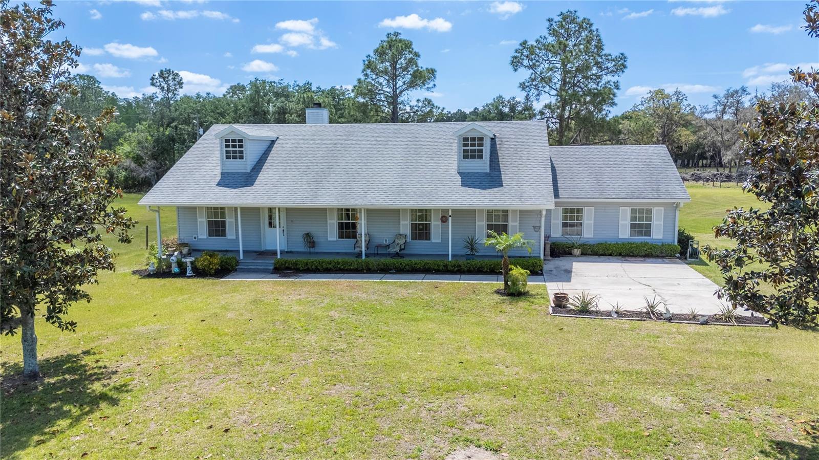 Spanning over 47 acres across three separate parcels, this exceptional property is just minutes from I-4, offering quick access to both Tampa and Orlando. The main residence features 3 bedrooms, 2.5 bathrooms, a spacious kitchen, a separate dining room, a wood-burning fireplace, and a primary suite set apart for privacy. Enjoy outdoor living with a covered front porch and a large screened-in back porch with a half bathroom. The property also includes a separate 1-bedroom, 1-bathroom apartment with a full kitchen and living room, attached to a 30x35 covered workshop/barn with concrete flooring, electric, and two storage rooms (9x11 and 14x9) with AC, one previously used as a tack room. The barn’s backside boasts three horse stalls with a newly replaced covered roof (2025). Additional amenities include a 20x40 three-sided pole barn for hay storage, two metal Conex containers with electric, a vehicle lift, two separate septic tanks, and fencing around the primary parcel. This versatile property is a rare opportunity. The primary parcel is 37.86 acres zoned Agriculture Residential Rural (ARRX), 2nd parcel 4.83 zoned Low or Inaccessible, 3rd parcel 4.84 acres zoned Low or Inaccessible.***Features and updates***
Primary residence Roof(2019), A/C(2019),septic pumped(2025), Water Heater(2020) wood burning fireplace, kitchen appliances, washer and dryer included. Barn Apartment bedroom 15x11, living room 12x15, full kitchen 8x15, updated backsplash(2024),living room repainted(2024), window unit replaced(2024), shower head with filtration system(2024), Septic to barn apartment replaced 4 years ago. Horse stalls area 22ft long with three separate doors, electric and rubber mats and roof replaced (2024), 85 gallon Well inside concreated pump house with GE breaker box, last maintenance (2024), Two fenced pasture areas, multiple gates throughout the fenced property, Barn has an exterior sink and fish cleaning area. All measurements are estimated and buyer should verify.