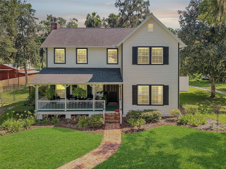 Step into a world of grace and tranquility in this exquisitely updated 3-bedroom, 3-bath residence, nestled in the storied heart of McIntosh’s historic district. This two-story home is a masterclass in Southern charm, where architectural heritage meets modern sophistication. Peace of mind is included with a new roof and gutter system, 2 new HVAC units, a new water heater, a recently installed water softener system, and updated electric- including a new circuit panel and breakers, and new electrical outlets and covers throughout the home. From the moment you arrive, the Florida-style front porch sets a welcoming tone, inviting you to unwind and savor the slower pace of small-town living. Inside, soaring ceilings, newly refinished hardwood flooring, crown molding, and beadboard wainscoting create a warm, elevated ambiance. The gathering room, anchored by a wood-burning fireplace, offers an inviting space for intimate evenings or elegant entertaining. A formal dining room, dedicated home office, and a recently added main floor full bath add function and flair to the well-designed living space. The thoughtfully remodeled kitchen features striking tile flooring, stainless steel appliances, a vented range hood, granite countertops, subway tile backsplash, generous pantry storage, and a built-in workspace. Upstairs, the owner’s suite offers a peaceful and private retreat, featuring a generous walk-in closet, a separate dressing room, and a spa-inspired en suite bath. The bath showcases a river rock-accented shower, granite countertops, and elegant tile finishes that evoke quiet luxury. Two thoughtfully designed guest bedrooms offer a blend of comfort and charm, complemented by a guest bath that features a timeless claw-foot soaking tub — perfect for unwinding in style. Just outside, a cozy window seat nestled on the landing adds a layer of character and warmth, creating a welcoming nook that enhances the home’s inviting ambiance. Additional highlights include mature landscaping with front-yard irrigation, a brand-new back deck with a retractable electric sunshade for effortless outdoor lounging, and a generous paver patio designed for elegant alfresco entertaining.  Enjoy a detached workshop/shed with electricity, a privacy-fenced yard with an aluminum gate, fresh exterior paint, and a two-car garage with a new door and opener, which provide both practicality and convenience.  This home’s fantastic location offers the tranquility of low Marion County taxes and easy access to Gainesville, Ocala, and the pristine waters of Orange and Lochloosa Lakes. This is more than a home — it’s a lifestyle offering charming yet modern living with grace, comfort, and enduring appeal.