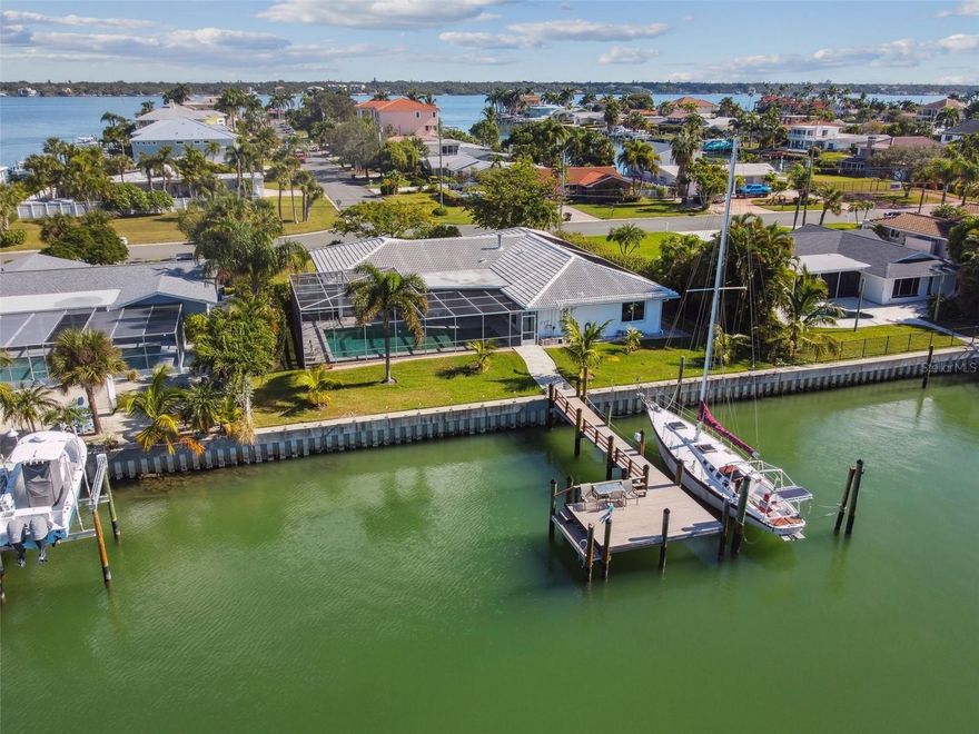 A wonderful opportunity to acquire this spacious Rutenberg home situated on 105 feet of waterfront on Capri Isle in Treasure Island, FL. This home presents an incredible canvas for someone seeking to personalize & create their dream waterfront haven. The layout invites endless possibilities for renovation and customization. Highlighting, 5 bedrooms, 3.5 baths, 2 car garage & perfect orientation of the home to maximize the use of natural sunlight. This home offers enough breathing space for the biggest family gathering with a free-flowing casual open plan living area where indoors & outdoors merge to become one spacious living area. This allows natural light to grace every corner of the home. Imagine the potential of crafting your own vision within this free-flowing space, where family gatherings feel spacious & connected. This home boasts a kitchen that's a hidden gem, poised to transform into an entertainer's dream. Imagine ample countertop space perfect for hosting, paired with an open design that seamlessly blends into additional living areas. It's a space primed for creating unforgettable moments with friends and family. You will indulge in the serenity of your private sanctuary where you will unwind in the spacious primary bedroom boasting not just one, but 2 expansive walk-in closets and an ensuite that's a true oasis, complete with a sauna for ultimate relaxation. Plus, enjoy seamless access to the refreshing pool and outdoor living space, creating a luxurious haven for both relaxation and entertainment. Bedroom 2 offers versatile possibilities—it's conveniently adjacent to the primary bedroom, making it an ideal space for an inspiring office, a cozy den, a tranquil library, or whatever suits your needs best. Discover two additional bedroom suites adorned with a charming Jack and Jill bath, each offering its unique allure. The final, spacious bedroom boasts a grand picture window, perfectly framing the stunning waterfront views to create a serene & captivating atmosphere. Experience the lavish retreat offered by this waterfront residence, boasting an oversized solar-heated pool enveloped by elegant pavers, inviting you for a year-round refreshing dip. New meticulously replaced seawall in 2016, ensuring a secure and enduring foundation. Adorned with a 14-year-old white barrel tile roof, designed to last a remarkable 50 years, this home showcases exceptional durability and timeless charm. Enhanced with storm doors and windows, a brand-new AC system, hot water heater, refrigerator, and washer & dryer, all installed in 2021, the home offers modern comfort and convenience.  Step outside to discover a sprawling wrapped piling dock, meticulously crafted in 2018, extending over 40 feet in length and 20 feet in width. Boasting 50-amp electric service, it stands poised to accommodate your choice of watercraft, ready for your maritime adventures. This residence not only boasts good bones but exudes immense potential, offering a canvas for your dreams to unfold. Embark on a myriad of water adventures right from your own backyard. With no fixed bridges to the Gulf of Mexico, the possibilities are endless. Step into an expansive yard and a screened-in living area that offers cool, soothing shade, perfect for indulging in Florida's balmy climate. Close to Treasure Island's beaches, the vibrant downtown of St. Petersburg, & access to 2 international airports. Reach out today to schedule a private showing. Your future of waterfront living awaits! Bedroom Closet Type: Walk-in Closet (Primary Bedroom).