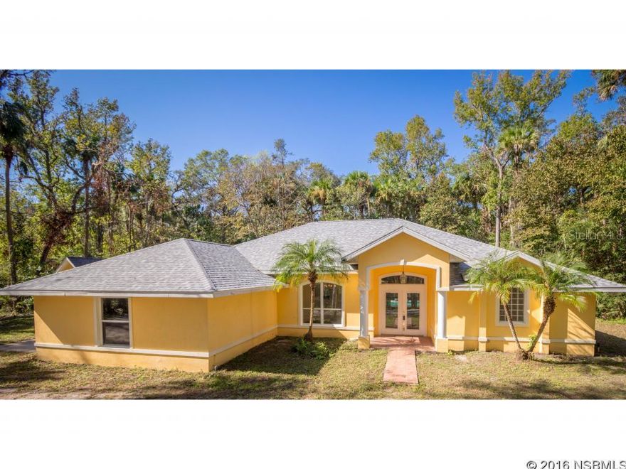 Under contract taking backups. Set on nearly 3 ACRES in the quiet subdivision of Mission Woods, this 3-Bedroom, 2-bath, CONCRETE BLOCK, POOL HOME offers CONVENIENCE, PRIVACY AND SERENITY.  Located just minutes from both the beach and I-95, this home features a spacious OPEN FLOORPLAN, SOLAR-HEATED INGROUND POOL with screen enclosure, 10-FOOT CEILINGS, NEW FLOORING and NEW APPLIANCES!  The NEW ROOF was installed September 2016. NEW AC AND GARAGE DOOR installed in 2015. The interior is freshly painted with tray ceilings in each bedroom, artful niches throughout, double entry front doors, and views of the pool from the kitchen, living room and master suite via 3 sets of French Doors. Master bath has a double-sink vanity, jetted soaking tub and a large walk-in shower. Outside, treed grounds could  appear more luscious with a little clearing.  Follow the path on the south side of the home to see the pond and meadow with gated access to Knittle Circle.  It's the perfect spot for BOAT STORAGE or RV/Trailer parking.  This home DOES NOT REQUIRE FLOOD INSURANCE. Underground Propane tank powers hot water heater and stove. All measurements are approximate.