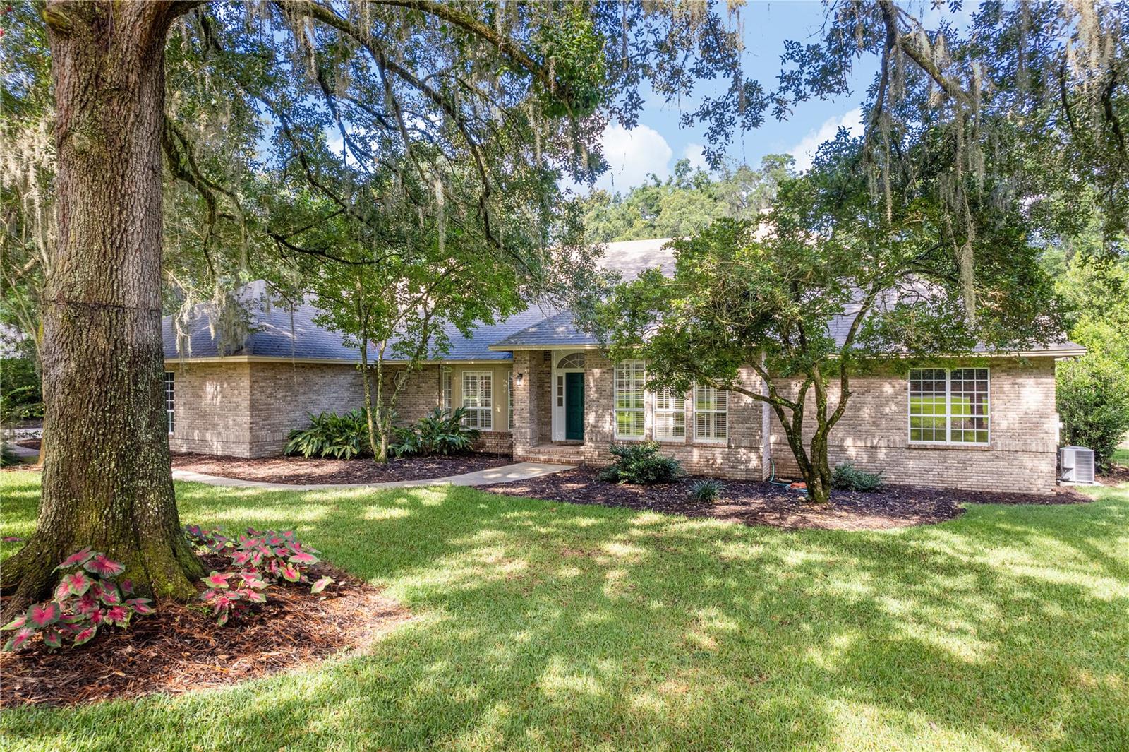 Welcome to this beautiful, brick home, tucked away on a lushly landscaped, one-acre lot in the SW Gainesville neighborhood of Kenwood. Offering nearly 3,250 square feet of living space, this 4-bedroom, 3-bath home blends luxury with modern updates and everyday comfort! Space is abundant in this special home. As you enter the home, the dining room opens to the kitchen and to the flex space. This can serve as a play room, a den or office…use your imagination! Beyond, the family room flows directly to the kitchen. The fireplace is a focal point of the room, while the vaulted ceilings and three sets of French doors open to the screened lanai—creating seamless indoor-outdoor living! Step outside to your private retreat, complete with pool and spa, perfect for relaxing with family or entertaining guests year-round! This back yard is incredible - lush gardens, plenty of grass, a paver patio with fire pit…Enjoy!
The updated kitchen is a chef’s delight… stone countertops, stainless steel appliances, ample storage, and a window over the sink offers a wonderful view of the property and functions as a convenient pass-through to the lanai for entertaining! Each bedroom is generously sized with large walk-in closets—ideal for the fashion-forward homeowner. The luxurious primary suite offers a peaceful sitting area with custom built-in bookcases, creating the perfect space to unwind!
Recent updates to the home include roof, A/C system, a new pool heater and a new driveway, ensuring that this home is ready for its new owners!