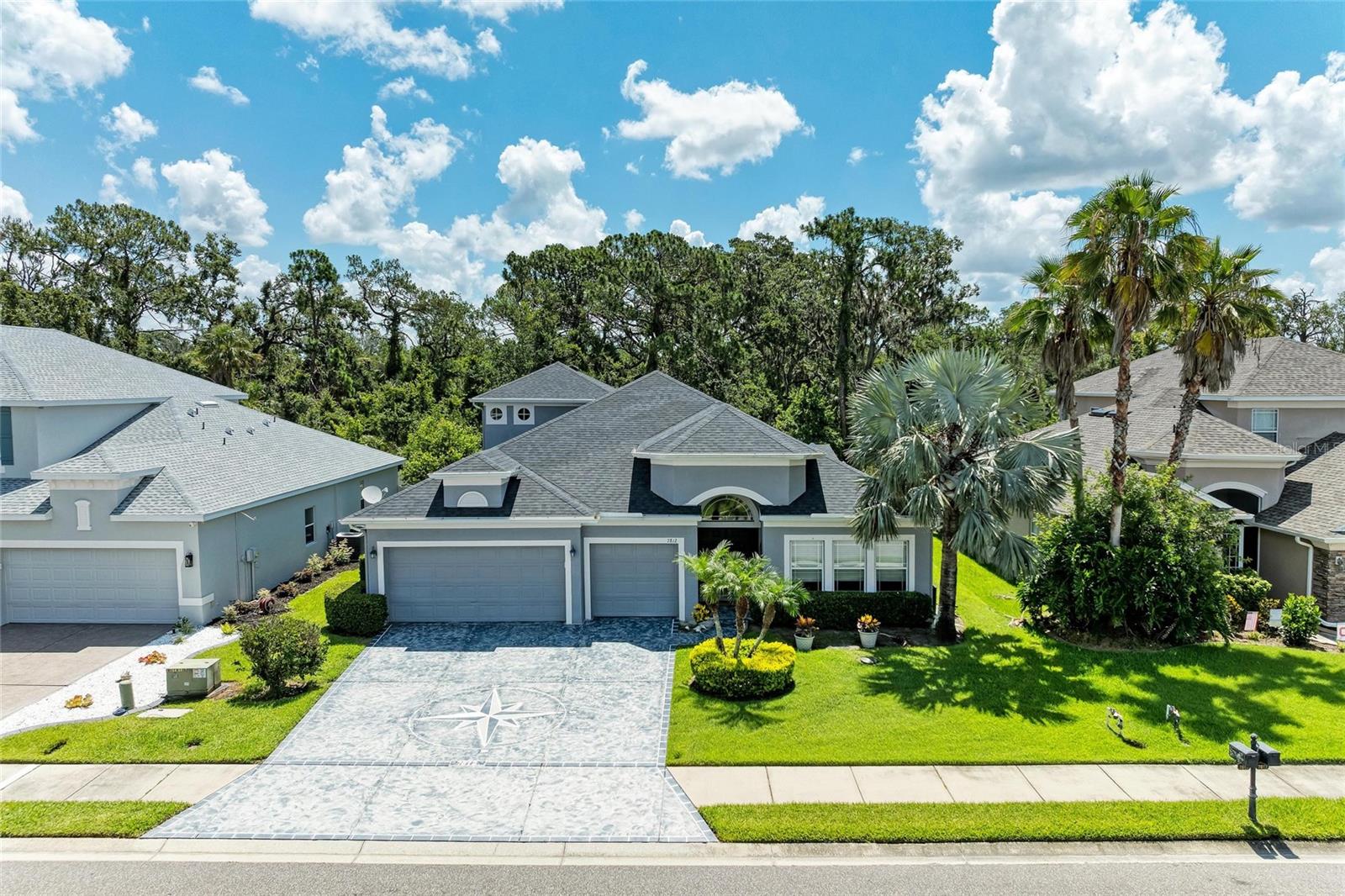 Welcome to this stunning 4-bedroom, 3-bathroom home, featuring a den with sliding barn doors and a spacious bonus room, all nestled on a private preserve lot. Enjoy outdoor living at its finest with an extended lanai that includes a portable hot tub, gas firepit table, and a fully equipped outdoor kitchen with grill, refrigerator, sink, and a large bar—perfect for entertaining. Inside, the gourmet kitchen boasts dark cabinetry with crown molding and valance, undercabinet lighting, granite countertops, center island, stainless steel appliances, and a reverse osmosis system. A large breakfast bar opens to the spacious great room, which features custom built-in shelving and TV unit and overlooks the lanai. The primary suite, located on the main floor, offers two closets and a luxurious bath with granite dual vanities, walk-in shower, and a jetted soaking tub. Bedrooms feature cozy carpeting, while tile flooring runs throughout the main living areas. Updates include new roof 2023, HVAC 2019, a buried 120-gallon propane tank connected to firepit 2019, water heater 2020, water purification system, exterior painting to include etched driveway. Community amenities include a clubhouse, pool, fitness center, playground, and sports court. HOA includes basic cable and internet. Situated in a highly desirable location with easy access to St. Pete, Tampa, Downtown Sarasota, and just minutes from Parrish Community Park, Ellenton Outlet Mall, UTC shopping, and the new Publix Plaza featuring Foxtail Coffee, restaurants, and services. Future developments in the area include a 200-bed trauma hospital, Home Depot, Chick-fil-A, Slim Chickens, and access to an exciting Lagoon community.
