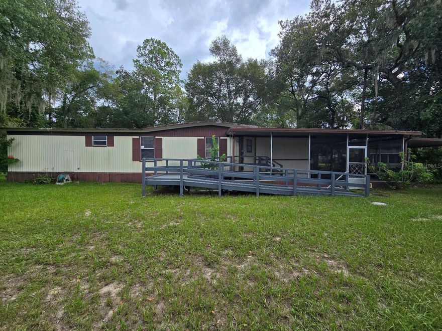 NO LOT RENT-  NO HOA- NO FLOOD ZONE-   ENJOY PRIVATE WATER ACCESS & BOAT RAMP TO NORTH LAKE !!!
2025 Updates include: Both bathrooms & Kitchen incuding counter tops , real pine wood cabinets & stove, interior paint, carpet, flooring & new Motor for the 5 ton Air Conditioner unit that also provides heat.   METAL ROOF OVER & updated water heater as well.  Washer/Dryer beside huge Walk in Closet.  Tons of storage areas & large Master Bedroom------Exterior features:  Oversized lot 1/3rd of an acre---Wheelchair/Walker Accessible Ramp/ Walkways to both front and back entrances- Covered Carport & parking area - Additional 20x25 Screened Porch- Storage Shed/ Workshop-  Partially fenced Yard &  Paved Road.

Silver Lakes Acres is a community located in the Ocala National Forest along Highway 40 in Silver Springs, FL.  It allows access to North Lake which provides great fishing, boating, and kayak/canoeing.  There is also a small beach for swimming.
Less than 3 minutes  from Winn Dixie & Dollar General & 13 minutes to Walmart.