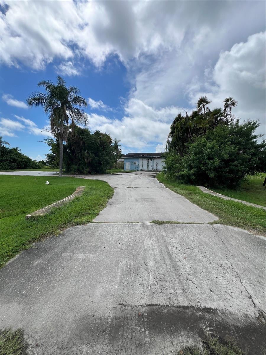~Ousley Estates~ .998 Acre in Ousley Estates- at the end on the cud de sac. 2 car garage (needs roof) Lots of concrete. City water & Sewer. Electric Box hookup. Private and is located on a little lake.(Not accessible to Lake O) Diamond in the rough! All measurements are approximate.