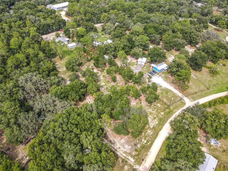Escape to your own private oasis on this impressive 1.55-acre parcel in peaceful Hawthorne! This partially cleared lot offers the perfect canvas for your dream home, whether you're planning a cozy manufactured home or an elegant custom build.

The groundwork is already done for you - literally! A well is in place and ready to serve your future home, while the electric pole stands at attention, practically saluting your arrival. The property comes partially fenced, giving you a head start on privacy and security. With a survey already on file, you can move forward with confidence knowing the boundaries are clearly defined.

What makes this location truly special is its elevated position - this land sits high and dry, a welcome relief in Florida! You'll enjoy the tranquility of rural living without sacrificing convenience. The area boasts several beautiful lakes including Cowpen Lake, Lake A-Ana, and McMeekin Lake, perfect for weekend fishing adventures or peaceful morning walks. The community embraces a laid-back lifestyle with no homeowner association fees or community development district charges weighing you down. Yet you're still within reasonable distance of shopping and dining options when civilization calls.

Camp Good News nearby offers recreational opportunities, while Hitchcock's Market provides convenient grocery shopping. Hawthorne Middle/High School serves the educational needs of local families.

This partially cleared, partially wooded lot strikes the ideal balance between privacy and accessibility. The quiet community atmosphere combined with the property's generous size and existing infrastructure makes this an exceptional opportunity for anyone ready to build their Florida retreat. All information deemed reliable but not guaranteed. Buyer to verify all facts, measurements, and property details independently.