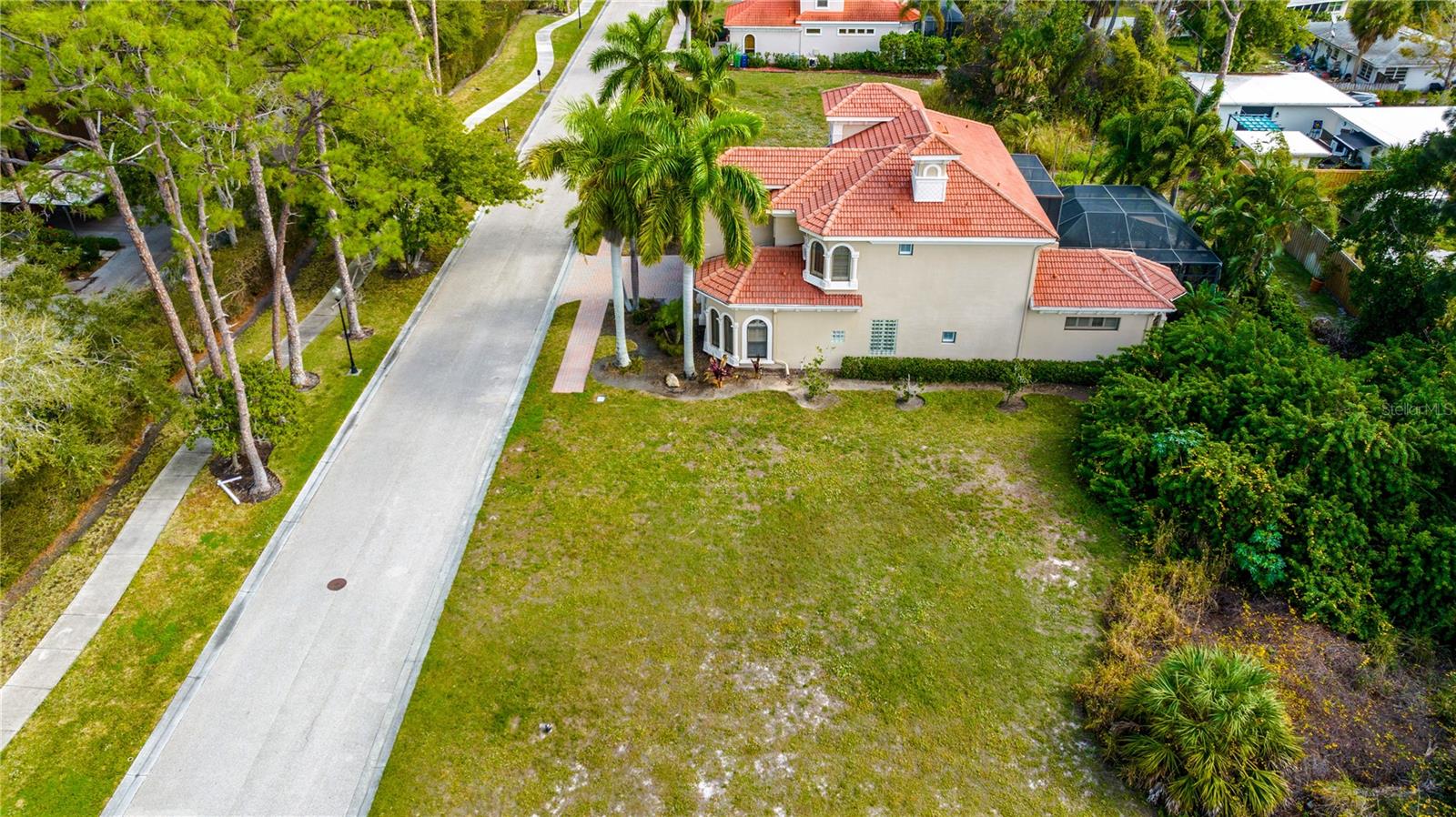 NOTHING ELSE LIKE THIS ON THE MARKET. MOTIVATED SELLER.
READY TO BUILD your dream home in this gated luxury home community on Little Sarasota Bay. NO FLOOD INSURANCE REQUIRED! This cleared lot features fiber optic cable, electric, sewer, water, and well-fed irrigation hook-up. All utilities are buried so there are no unsightly cables. Community boat slip with electricity and water is right at the end of the short road in this quiet South Sarasota Bayfront community with only 20 homes/homesites. Conveniently located minutes to Siesta Key Beach, Nokomis Beach, Casey Key, Sarasota Square Mall, US 41 and I-75. This gorgeous neighborhood is so quiet and tucked away, you'll never know how close you are to some of Sarasota's finest restaurants, shops, and local businesses! To keep the continuity of the Mediterranean neighborhood, all home plans must be submitted to the HOA for approval. This lot does not come with a private dock/boat slip, but the community slip is almost always available
Community did NOT flood during this last hurricane season!