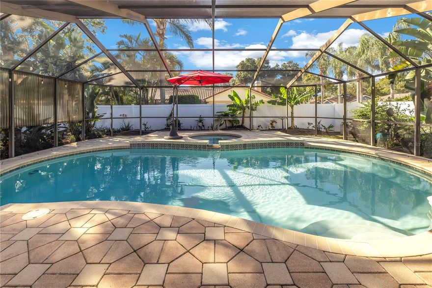 POOL PARADISE ON A CORNER LOT – WON’T LAST LONG !! This spacious split plan 4 bedroom, 2 bath, pool home has it all! The kitchen showcases gorgeous hardwood cabinetry, granite counter tops and New stainless steel appliances (all new 2022). Natural gas is available in this home for the following: range, water heater, laundry and fireplace. Enjoy the best that Florida has to offer with the expansive outdoor living area. The huge under-roof lanai showcases a vaulted screen enclosure and overlooks the resort style pool and spa. The pavered pool deck is large enough for all your patio furniture or grilling station needs. The large yard is fully enclosed with privacy fencing and includes a shed for additional storage. An additional pavered parking pad is ready for a boat, trailer or RV – BRING YOUR TOYS! Entertaining here is made easy with the open concept kitchen, large living room and additional family room both boasting a vaulted ceiling and upgraded light fixtures. If you are looking for a cozy place to have your morning coffee or a great spot for a firepit, look no further than the private open-air pavered patio located off of Bedroom #2. The spacious master bedroom has an en-suite bath, walk-in closet and sliding doors leading to the screened-in lanai. All bathrooms feature updated vanities with granite counter tops. Nothing has been missed in this home – New AC (2020) including ducts cleaned and resealed, New Water heater (2021), updated tile flooring throughout, pool was resurfaced (2012) and is heated by solar panels, lush landscape is easily maintained with the sprinkler/irrigation system, and home is fully equipped with a water softener. Plenty of storage here with the oversized 2 car garage, shed and tons of closets. The inside laundry room makes chores a breeze with the additional cabinetry and utility sink. Close to Shopping, Restaurants and just minutes from the Gulf Beaches. A quick closing is OK here. No HOA, no flood zone – SAVES YOU MONEY $$ !!