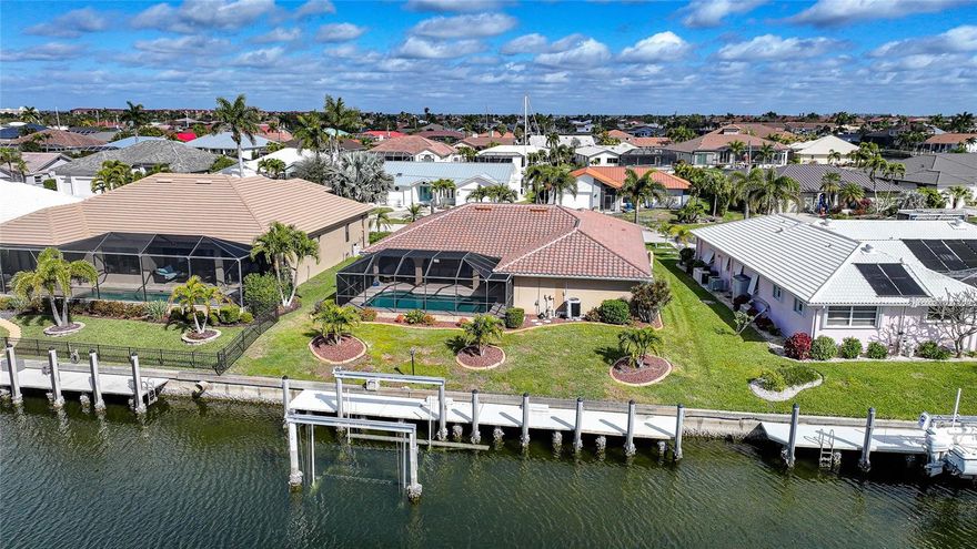 Punta Gorda Isles Quick Sailboat Gulf Access Pool Home. Welcome to 2817 Don Quixote Drive — where waterfront living meets comfort, style, and true Florida charm. This 3 bedroom, 2 bathroom, 2-car garage pool home offers the perfect blend of indoor elegance and outdoor enjoyment, complete with a private dock, boat lift, and extended dock for maximizing your time on the water. Step inside and immediately appreciate the spacious feel created by soaring cathedral ceilings and an open, flowing layout designed for both everyday living and entertaining. Pocket sliding glass doors seamlessly disappear, bringing the outdoors in and opening the main living areas to the lanai and sparkling pool. Whether hosting guests or enjoying a quiet evening at home, this design makes the most of Florida’s sunshine and waterfront lifestyle.

The kitchen is beautifully appointed with granite countertops, ample cabinetry, and generous prep space — perfect for cooking and gathering. The primary suite is a relaxing retreat featuring his-and-her closets, custom closet systems, and private access to the lanai. The additional bedrooms are well-sized and thoughtfully designed, offering comfort and flexibility for family or guests.

Outside, your screened lanai is equipped with convenient roll-down shutters, creating both storm protection and added privacy. The inviting pool overlooks the water, setting the stage for relaxing afternoons and sunset views. Boating enthusiasts will love the private dock with boat lift and extended dock, providing easy access for larger vessels and making waterfront adventures effortless.

Additional highlights include Bahama-style shutters that enhance curb appeal and function, custom closets throughout, and a well-maintained two-car garage offering extra storage space. Major systems have been thoughtfully updated for peace of mind, including a roof just 1 1/2 years old, air conditioner 5 years old, water heater 1 1/2 years old, pool pump 1 1/2 years old, and pool heater 1 year old.

Located in a sought-after waterfront community just minutes from downtown Punta Gorda’s dining, shopping, parks, and entertainment, this home delivers the ultimate Southwest Florida lifestyle — boating, poolside relaxation, and beautiful canal views right from your backyard. Schedule your private showing today and experience waterfront living at its finest.