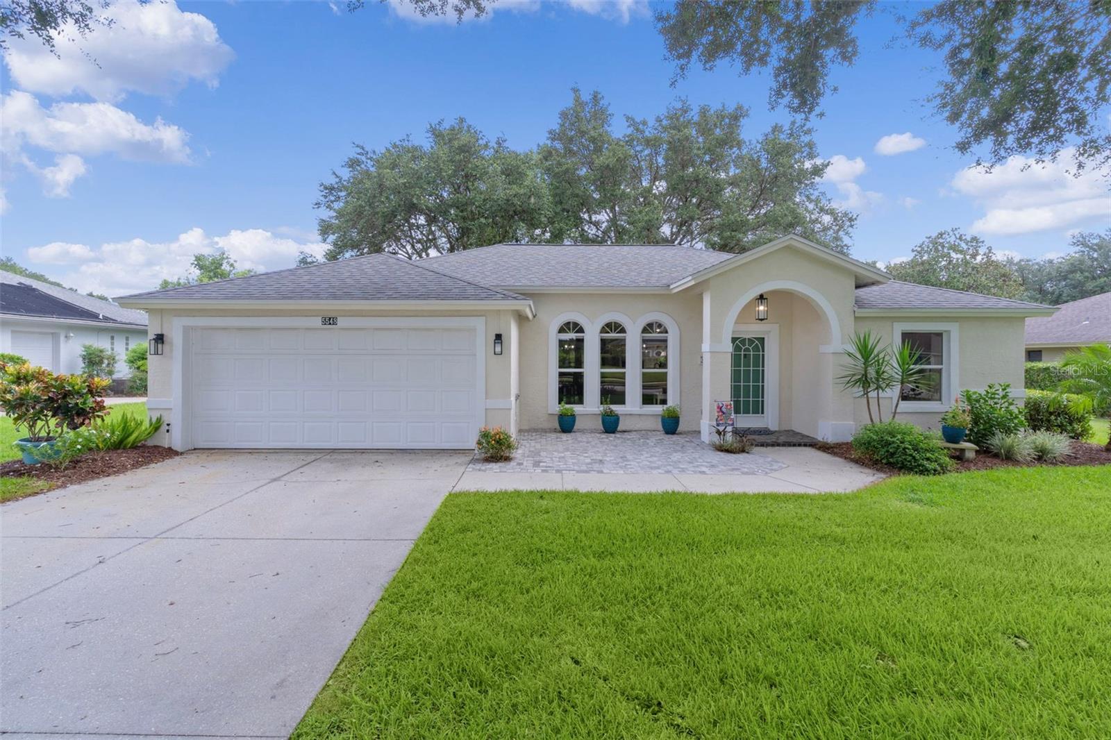LOW HOA fee of $77/month! Home in The Grove at Harbor Hills in a guarded gate community! This home is ready to move into! Owner remodeled with the intention to stay so you know that the quality is not that of a flipped home! Everything has been redone down to the switch plates! New in the home you will find the following: Pergo flooring throughout* wider 5” baseboards (even in the closets!)* Door frames have been updated to match the rectangular design of the new shaker style cabinets* lights & fans inside & out including lamp post, garage side lights & outdoor entryway* slider from the kitchen to the lanai*door knobs* entry keypad*bathroom vanities, sinks and tub, tile surround & shower with all new fixtures*garage floor repainted* Kitchen appliances are 3 years old and hardly used. Roof (2020) HVAC (2025) Hot Water Heater (2024). The plumbing in the home has been totally re-piped in 2024* (highly important feature for homes in this community which were built with copper pipes/plumbing). Even the sprinkler box is NEW! For storage, two closets have been added! One in the entry way that can be used for sweepers, switfters etc and one in the Primary Bedroom, which now has a built-in closet as well as a walk-in closet. The remodeled kitchen has new cabinets which include TWO pantries, and an island that is open to the dining area and living room. Quartz counters in the Kitchen and guest bathroom exemplify the updated look of this gorgeous home! Cabinets & shelves have also been added to the indoor laundry room for all your storage needs! Walls throughout the home are freshly painted in neutral tones. For a bit of color, the kitchen was painted with a darker color to highlight the white cabinets! Is there anything left to do?! Time to move right in! If you are looking for a community with mature landscaping and your neighbors more than a “stone throw away” then make an appointment to see your new home! This community is approximately 10 minutes to The Villages, shopping & restaurants, but the drive home takes you by open green areas where you might see horses or sheep! Airports, Disney and the ocean are approximately an hour and 15 minutes away. Residents may choose to become social members at the clubhouse for an additional fee. Please call the clubhouse for information on how you can enjoy features such as pickleball, tennis, indoor racquetball, sauna and weight room. The breathtaking views overlooking Lake Griffin from the gorgeous pool might alone just be with the membership! If you would rather be on the lake than observing the view, there is also an opportunity to use the marina! The clubhouse restaurant is just perfect for your needs after golfing, swimming or boating. Information deemed reliable & true but should be independently verified by buyer(s). Furniture available separately.