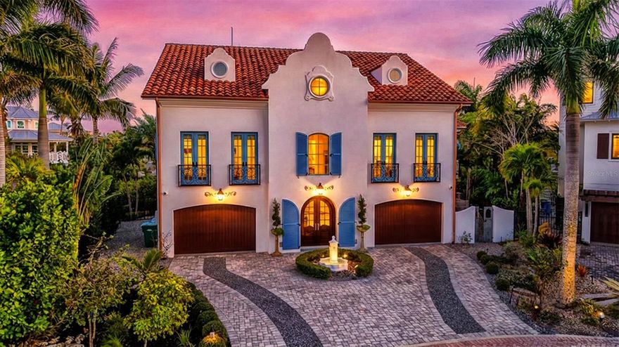 Rarely does a home of this architectural distinction and waterfront presence become available on Anna Maria Island. Tucked within the private residential enclave of Villa Rosa, this custom-built coastal estate offers a level of craftsmanship, privacy, and lifestyle reserved for the island’s most exceptional properties. Inspired by timeless European architecture, the residence is defined by reclaimed wood beams, marble flooring, handcrafted millwork, and curated designer finishes that create interiors both refined and welcoming. The chef’s kitchen serves as the heart of the home, featuring a statement Lacanche range, Sub-Zero refrigeration, custom cabinetry, and an expansive island designed for gathering and entertaining. Outdoor living unfolds as a private resort experience. A fully equipped Lynx outdoor kitchen, built-in pizza oven, covered lounge with wood-burning fireplace, and multiple terraces create effortless spaces for entertaining or quiet retreat. The rooftop observation terrace offers panoramic island views and becomes the perfect setting to watch sunsets paint the sky over the Gulf. Surrounded by lush tropical landscaping, the private pool and grounds evoke the feeling of a secluded coastal sanctuary. Positioned on a protected deep-water canal with direct, bridge-free access to Tampa Bay and the Gulf of Mexico, the private dock and 10,000-pound lift allow boating to become part of everyday life. Villa Rosa is one of Anna Maria Island’s most desirable residential communities, where rental restrictions preserve a quiet, private neighborhood atmosphere free from transient turnover. Just moments away, residents enjoy world-renowned powder sand beaches, waterfront dining at iconic destinations, boutique shopping along Pine Avenue, and the relaxed coastal lifestyle that defines Anna Maria Island. This is more than a home. It is a rare opportunity to own one of the island’s most architecturally significant and lifestyle-driven waterfront residences. Matterport tour is available.