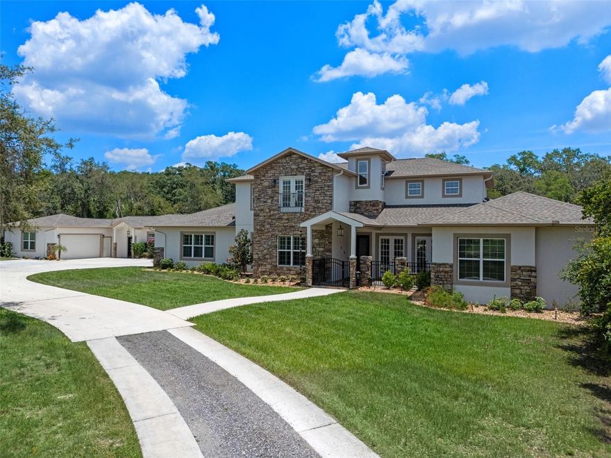 Welcome to Your Dream Estate in the Scenic Sugarloaf Mountain Area!

This exceptional multi-generational custom-built estate is nestled on 5.27 acres of beautifully landscaped property framed by majestic oak trees. Freshly painted and packed with luxury features, this home is designed for comfort, entertainment, and long-term living.

The main residence boasts four spacious bedrooms, five full bathrooms, one half bath, and a three-car garage. At the heart of the home is a chef’s dream kitchen featuring custom wood cabinetry, a built-in oven and microwave, gas cooktop, massive island, and high-end stainless steel appliances. The soaring 20-foot ceilings in the living room are complemented by exposed wood beams, a retractable chandelier, stone accent wall, and a cozy electric fireplace—all creating a warm and elegant atmosphere.

The primary suite opens directly to the pool lanai and includes a spa-like en-suite with dual vanities, a luxurious rain shower, and dual walk-in closets. The custom laundry room is equally impressive with extensive cabinetry, a farmhouse sink, second dishwasher, and premium washer and dryer.

Step outside to your own private resort-style oasis featuring a custom saltwater pool with spa, covered lanai, and a fully equipped outdoor kitchen with a grill, pizza oven, sink, and bar seating. A full bathroom is conveniently located on the pool deck.

For entertainment and relaxation, enjoy two axe-throwing stations, a regulation horseshoe pit, and a wood-burning fire pit area surrounded by custom pavers and ambient lighting.

The in-law guesthouse offers incredible versatility with two additional bedrooms, two and a half bathrooms, laundry, two large bonus rooms, and a two-car garage. Its beautifully designed kitchen includes a gas range, farmhouse sink, and abundant  cabinetry. Ideal for extended family or long-term guests.

Additional upgrades include: Solar panels (owned),  Plantation shutters, Luxury finishes throughout

This is the perfect estate for multi-generational living or those who simply want room to spread out in style and comfort.

Don’t miss this rare opportunity!
Ask your Realtor for the Feature List, Floor Plan, 360° Virtual Tour, and Video Tour today.