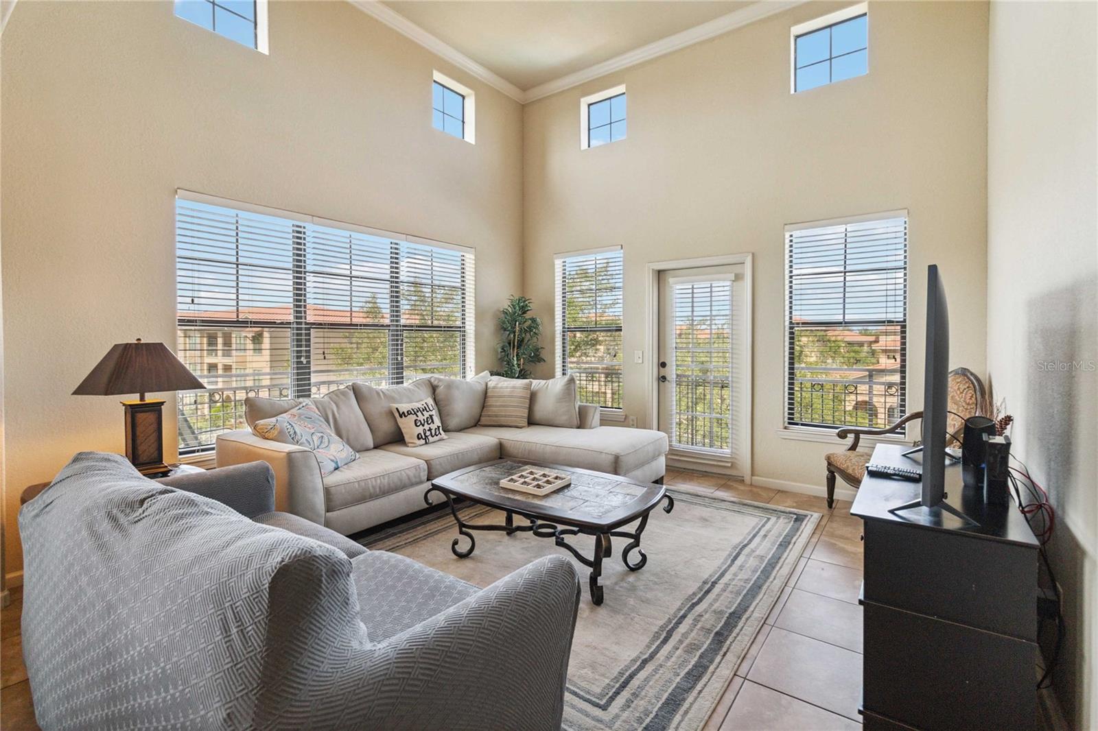 FURNISHED CORNER UNIT WITH POOL VIEW AND HIGH CEILINGS - This unique and spacious unit features soaring ceilings in the living area, allowing for abundant natural light and an open, airy feel. Enjoy a wrap-around balcony overlooking the community
pool-perfect for relaxing or entertaining. The open-concept layout includes a kitchen with granite countertops, ample cabinet space, and a warm Tuscan-style design. The
building is equipped with an elevator for added convenience. Located just off Hwy 27, the community offers quick access to major highways, shopping, dining, and is approximately 15 minutes to
Disney and 20 minutes to other popular Central Florida attractions.