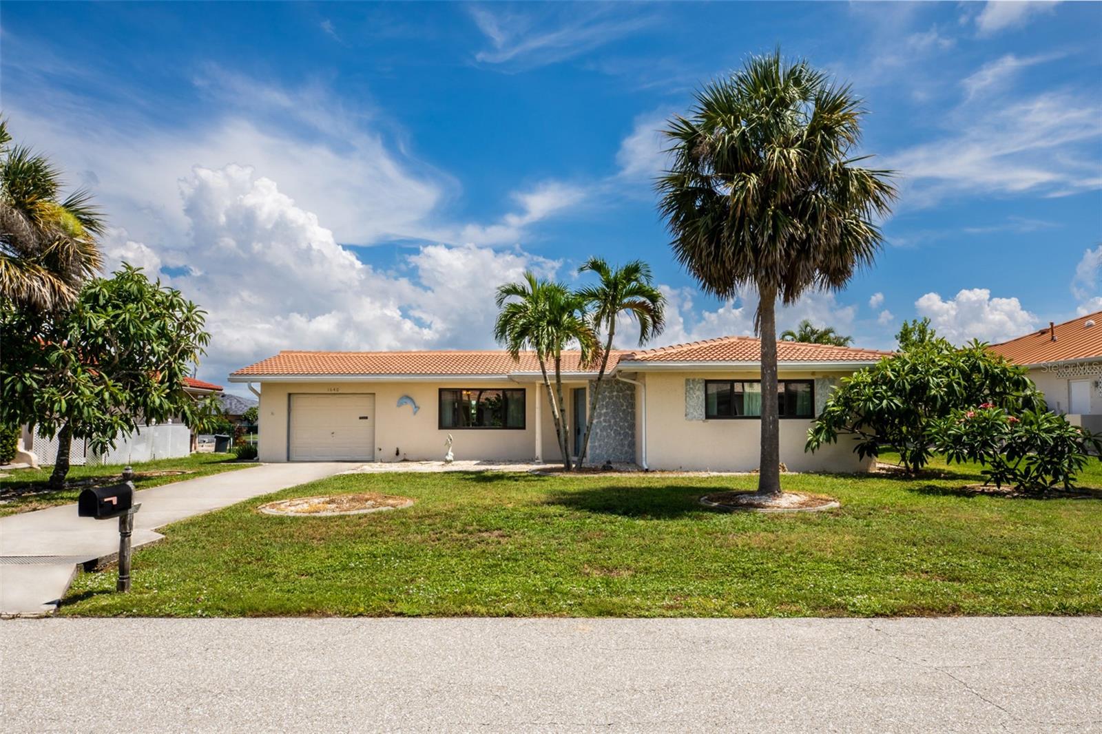 CHARMING WATERFRONT 2 Bedroom, 1.5 Bathroom, 1 Car Garage, Pool home with a Family room situated on a cul-de-sac with 78 feet of water frontage in the highly desirable Punta Gorda Isles. 2024 ROOF & NO HOA FEES!! CLICK ON THE VIRTUAL TOUR LINK 1 FOR THE VIDEO AND VIRTUAL LINK 2 FOR THE 3D TOUR. Featuring a bright & airy floor plan, tile flooring throughout, BEAUTIFUL water views, and MUCH MORE! Seamlessly entertain friends and family with an open living and dining room that flows to the kitchen and family room. An EAT-IN kitchen offers ALL stainless-steel appliances, ample counter space, a cabinet pantry and a service window with breakfast counter to the family room. The family room has large windows and a glass slider for plenty of natural lighting and PICTURESQUE water views, making it the perfect spot to enjoy your morning coffee or unwind with your favorite evening beverage. The master suite has a glass slider to the back patio, a walk-in closet, and an en-suite jack-and-jill style bathroom with a private single sink vanity & toilet with access to a shared tub/shower combo. The guest bedroom has a built-in closet and nearby access to the jack-and-jill style bathroom with its own private single sink vanity & toilet. Expand your entertaining space to the partially fenced backyard with a covered patio, a heated pool, perfect for year-round use, and 78 feet of concrete seawall. Set sail for endless water adventures from a private 12x5 dock with a 10,000-lb boat lift. Enjoy all the amenities that Punta Gorda has to offer, such as biking, fishing, boating, dining, live entertainment, and much more! Close to Fisherman's Village, Ponce De Leon Park, Gilchrist Park, and Historical Downtown Punta Gorda. Just a short car ride to award-winning beaches! Schedule your showing TODAY!