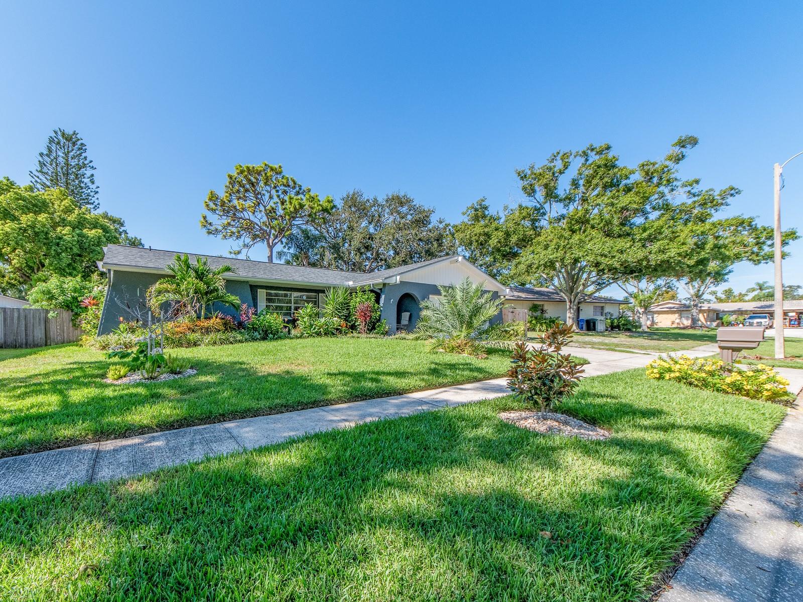 Location is everything! This property is not in a flood zone. Come check out this 4 bedroom, 2 bath with a 2 car garage POOL home on a nice Cul-De-Sac street! Located in a North Pinellas County neighborhood situated between US 19 and Belcher Rd. which provides easy road access to many close by amenities such as great shopping, restaurants, banks, etc. Not far from Honeymoon Island State Park known for its beautiful beach and nature trails. The floor plan offers a split bedroom layout. Primary bedroom with sliding doors opening out to the lanai, has an en-suite bathroom and walk in closet. NEED an OFFICE? On the opposite side of the home, you have 3 rooms that can all be utilized as bedrooms or 2 can be with one used as an OFFICE. The kitchen overlooks the family room and looks out to the fenced in yard and pool. Kitchen features white cabinets and newer appliances. Home has a newer roof (2023), heated salt water lagoon pool (2023), And lush landscaping adds to the tropical enjoyment of the home.